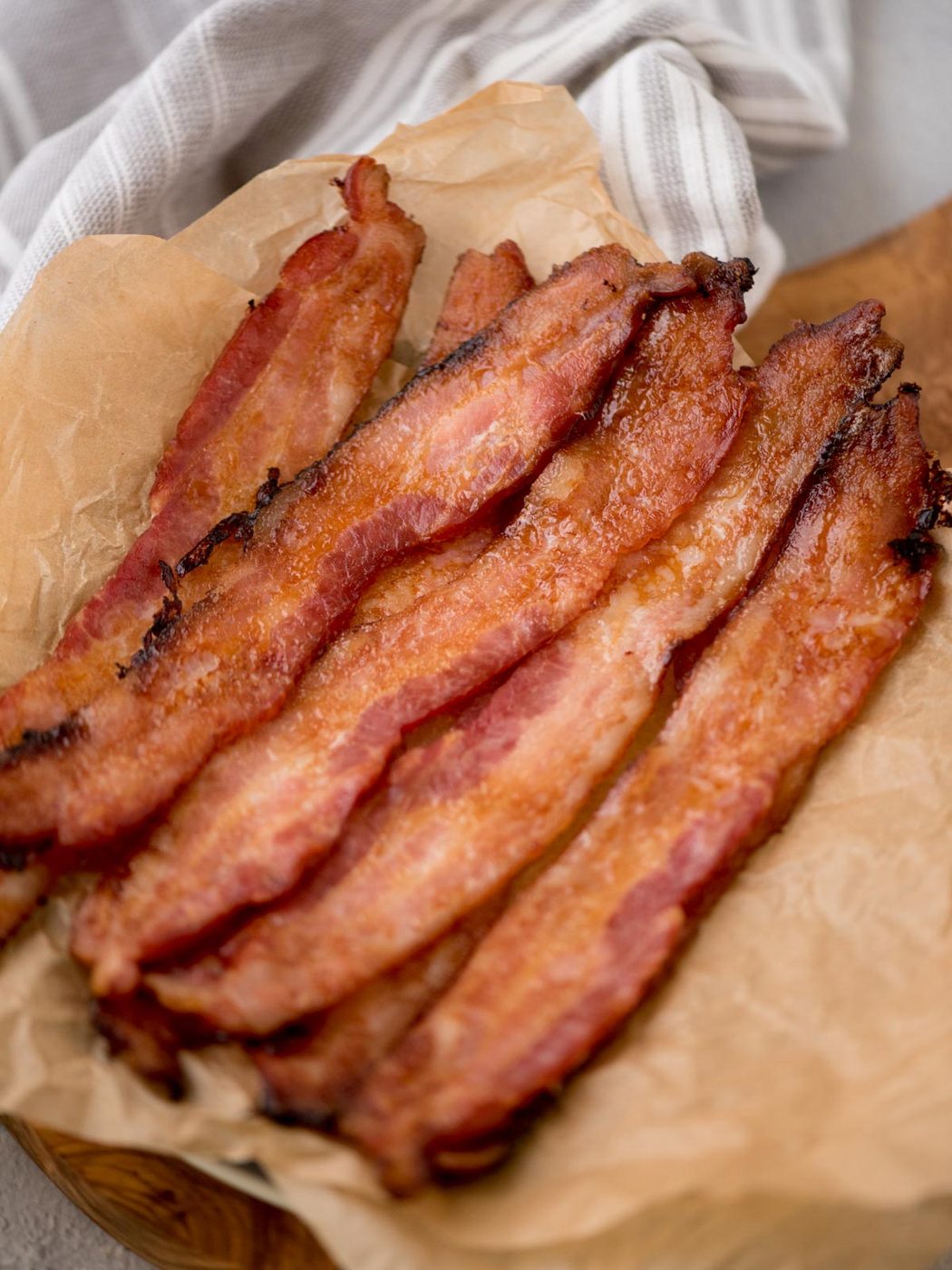 Crispy honey bacon served in a parchment paper covered platter.