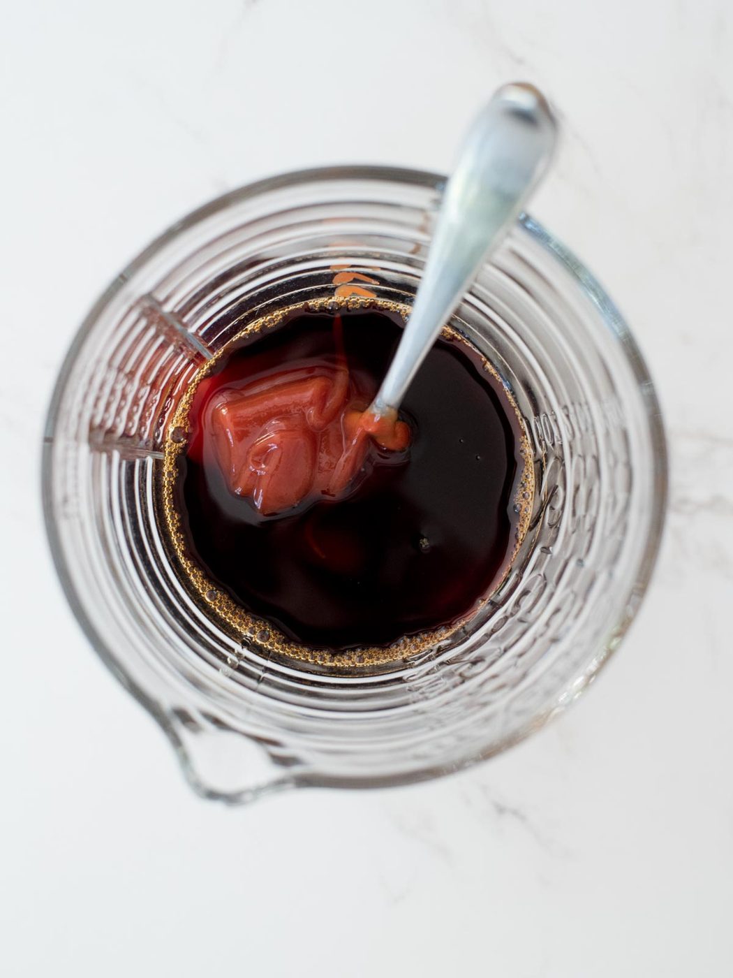ketchup added to the soy sauce in the measuring glass
