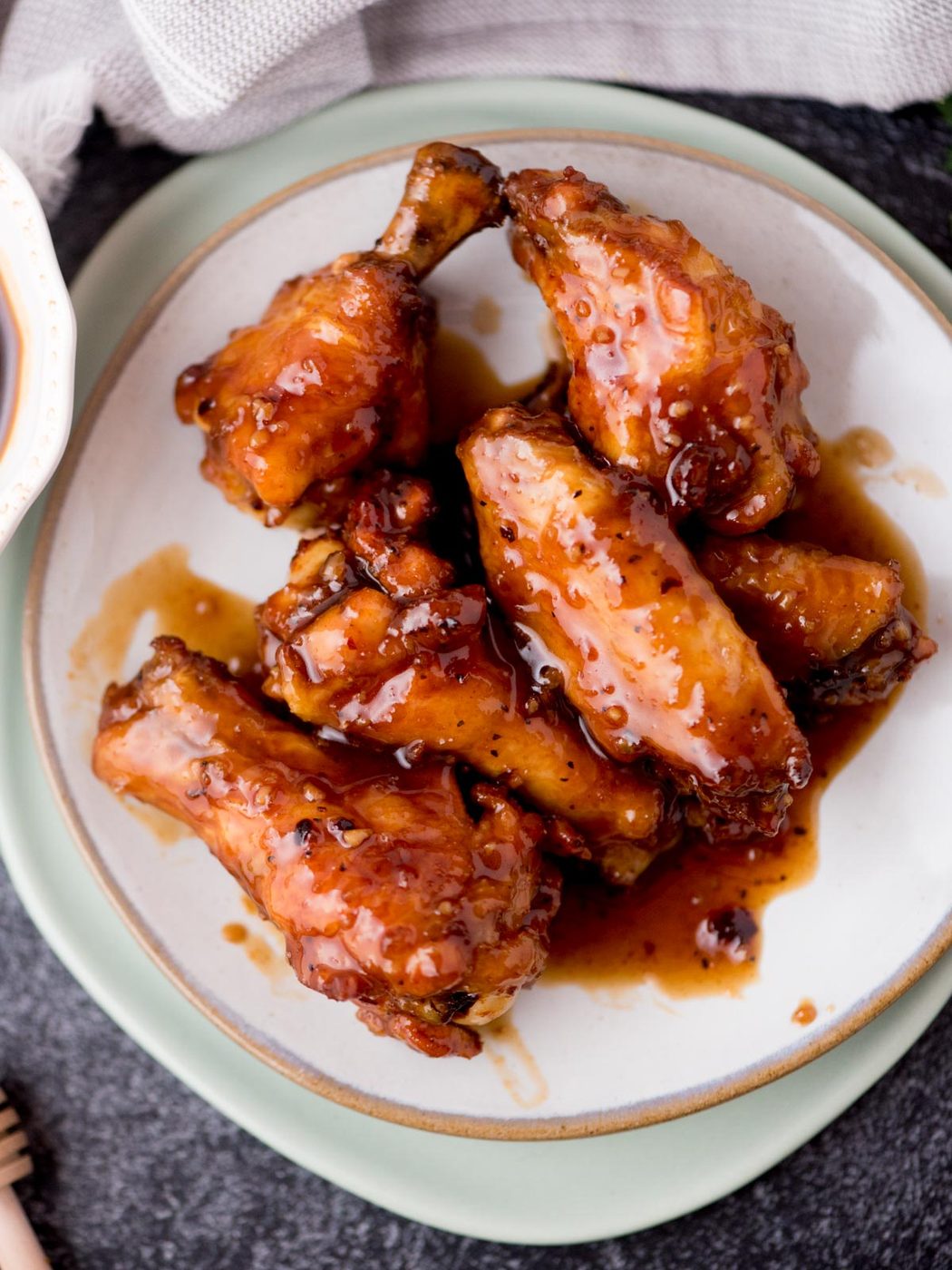 honey garlic chicken wings on a white plate