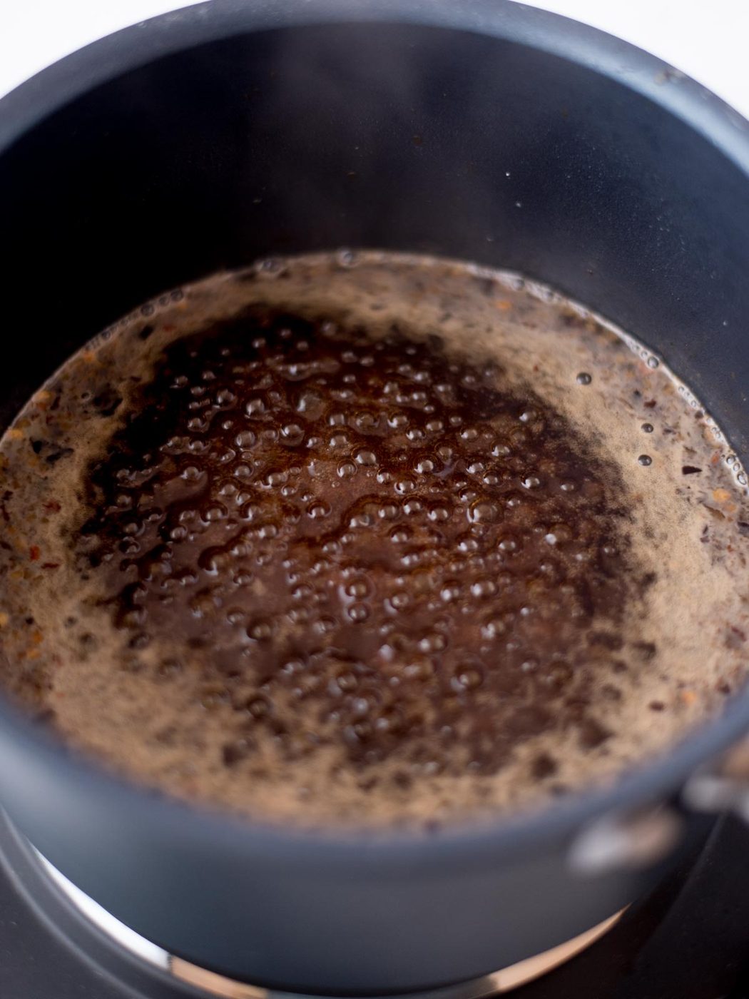 honey garlic sauce simmering in a saucepan