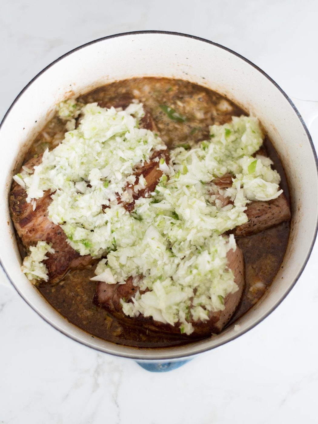 seared pork butt covered in onions jalapenos and garlic