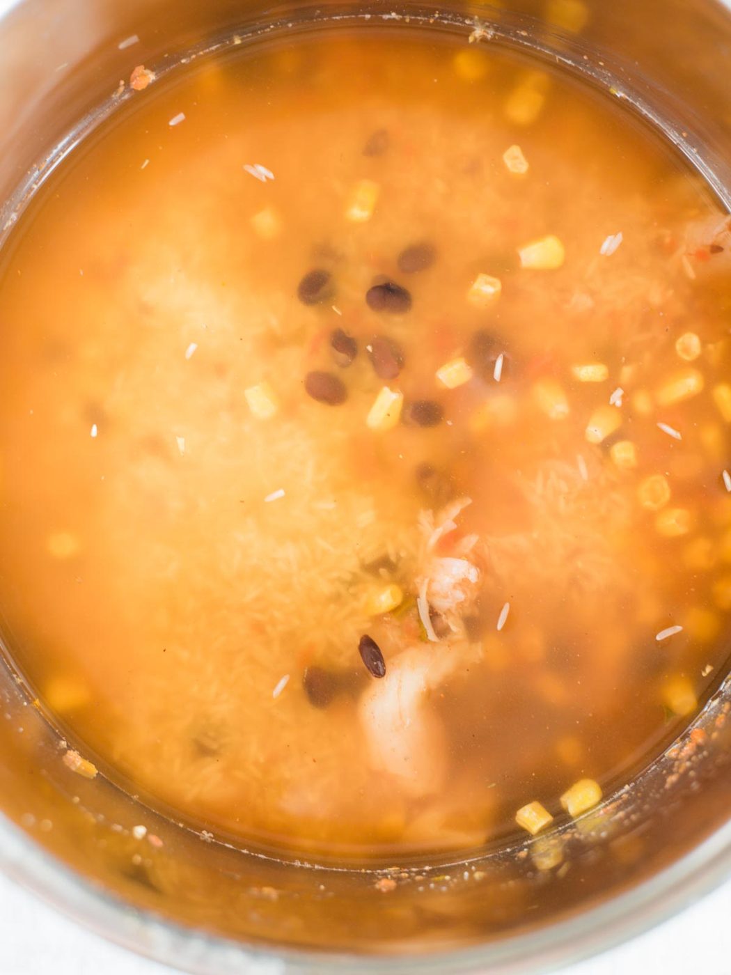 all ingredients in the instant pot sleeve with broth
