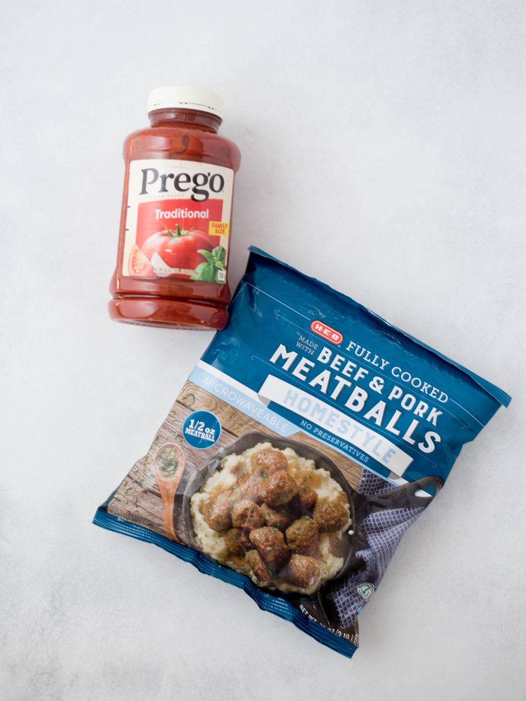 Bag of frozen meatballs and a jar of tomato sauce.