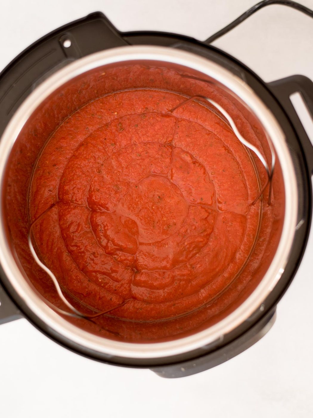 Tomato sauce added to an instant pot.