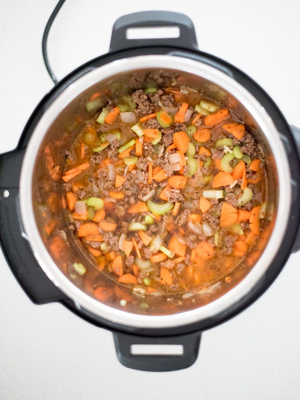 broth added to the instant pot to make instant pot spaghetti with meat sauce