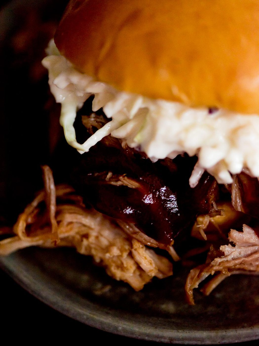 instant pot sweet pulled pork with bbq sauce and coleslaw in a brioche bun