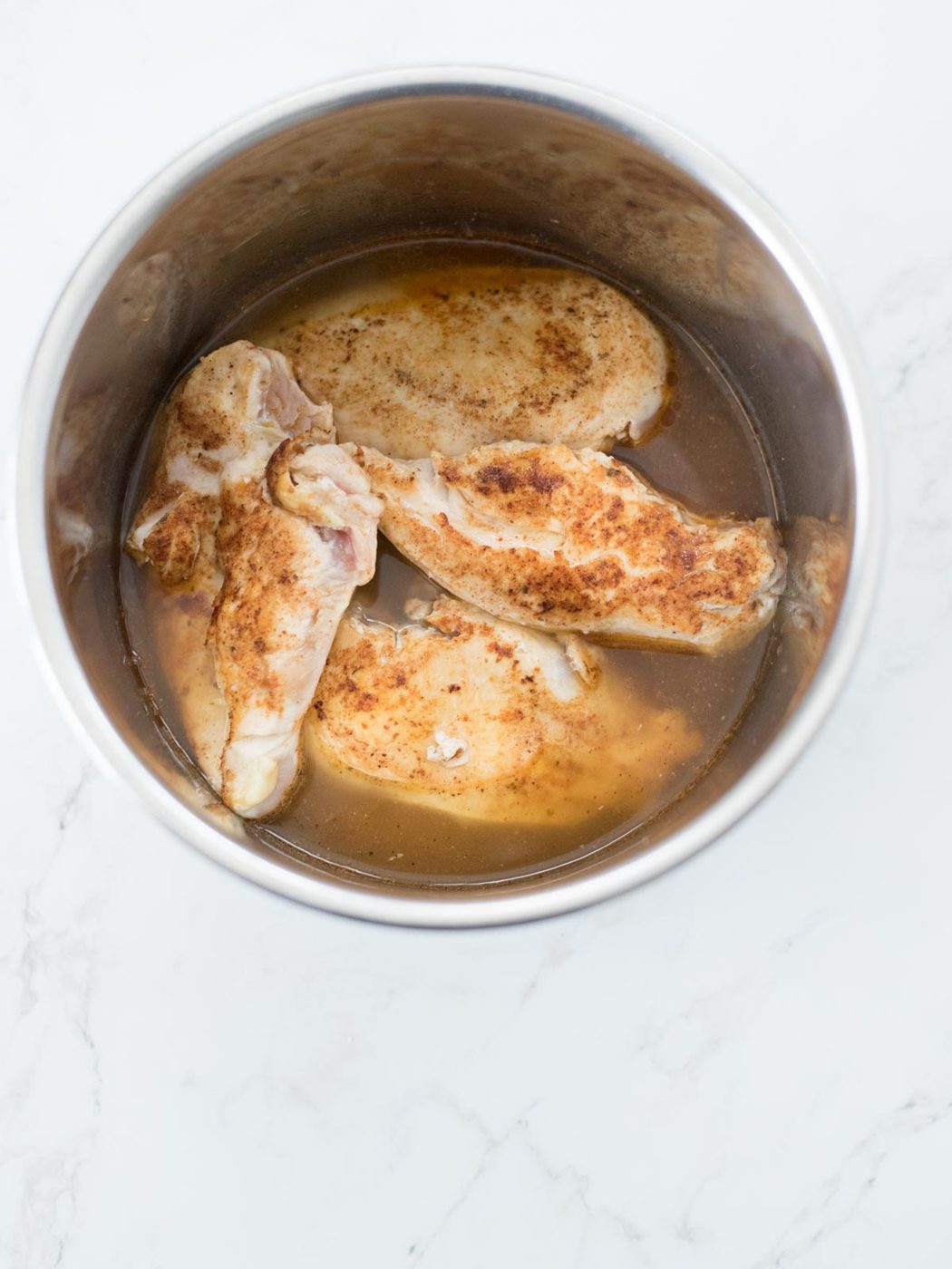 chicken broth with seared chicken in an instant pot