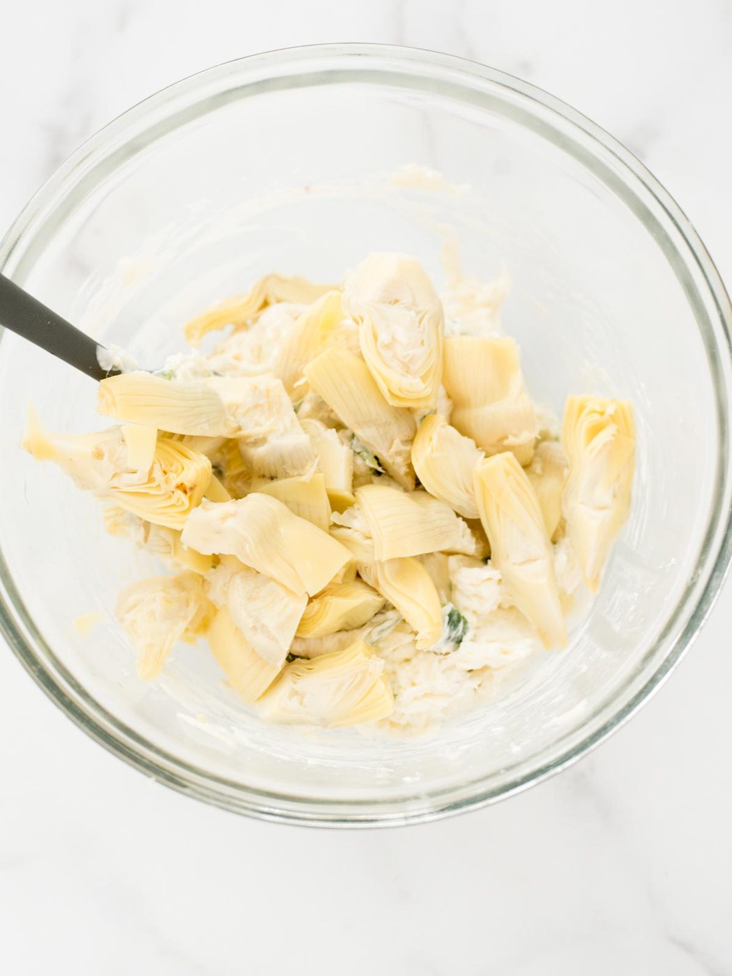 Artichokes added to bowl