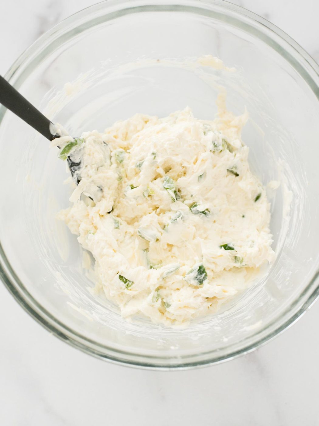 Jalapeno Artichoke Dip mixed up in bowl