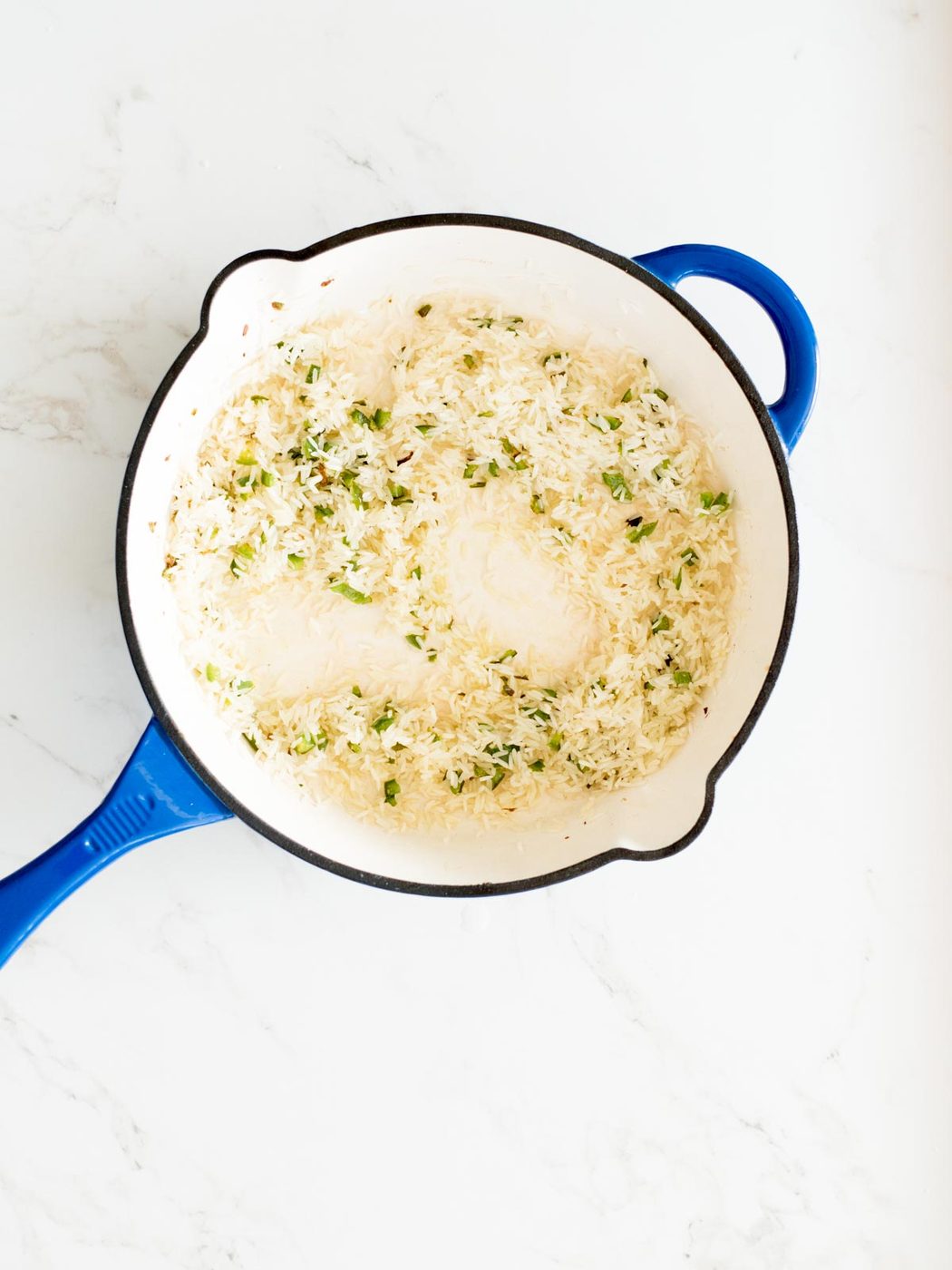 toasted rice in a cast iron skillet