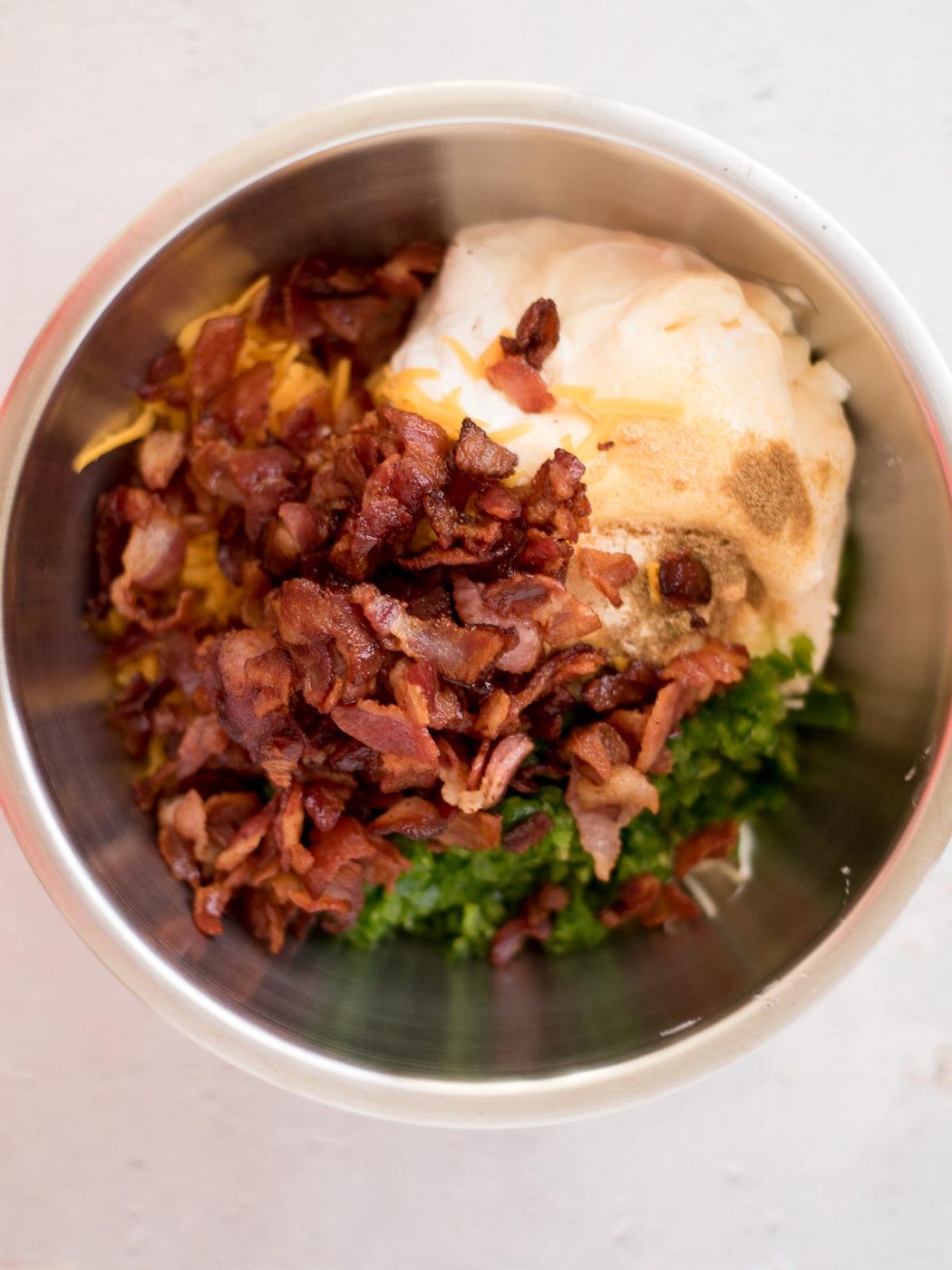 all of the ingredients to make jalapeno popper dip in a mixing bowl