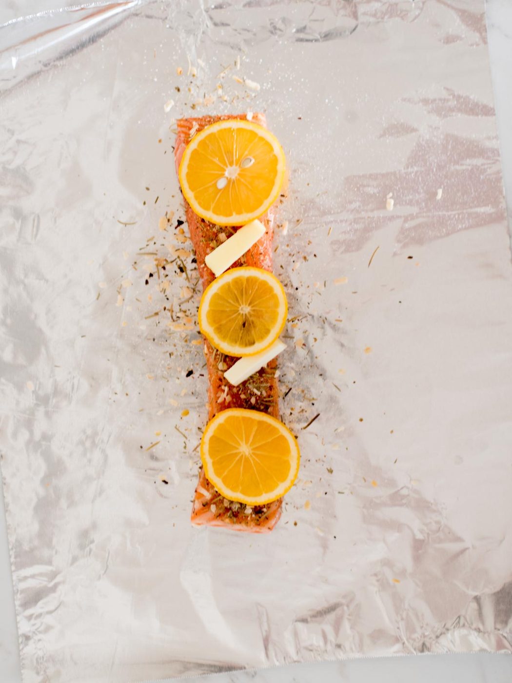 salmon filet with tuscan herb seasoning, butter, and lemons