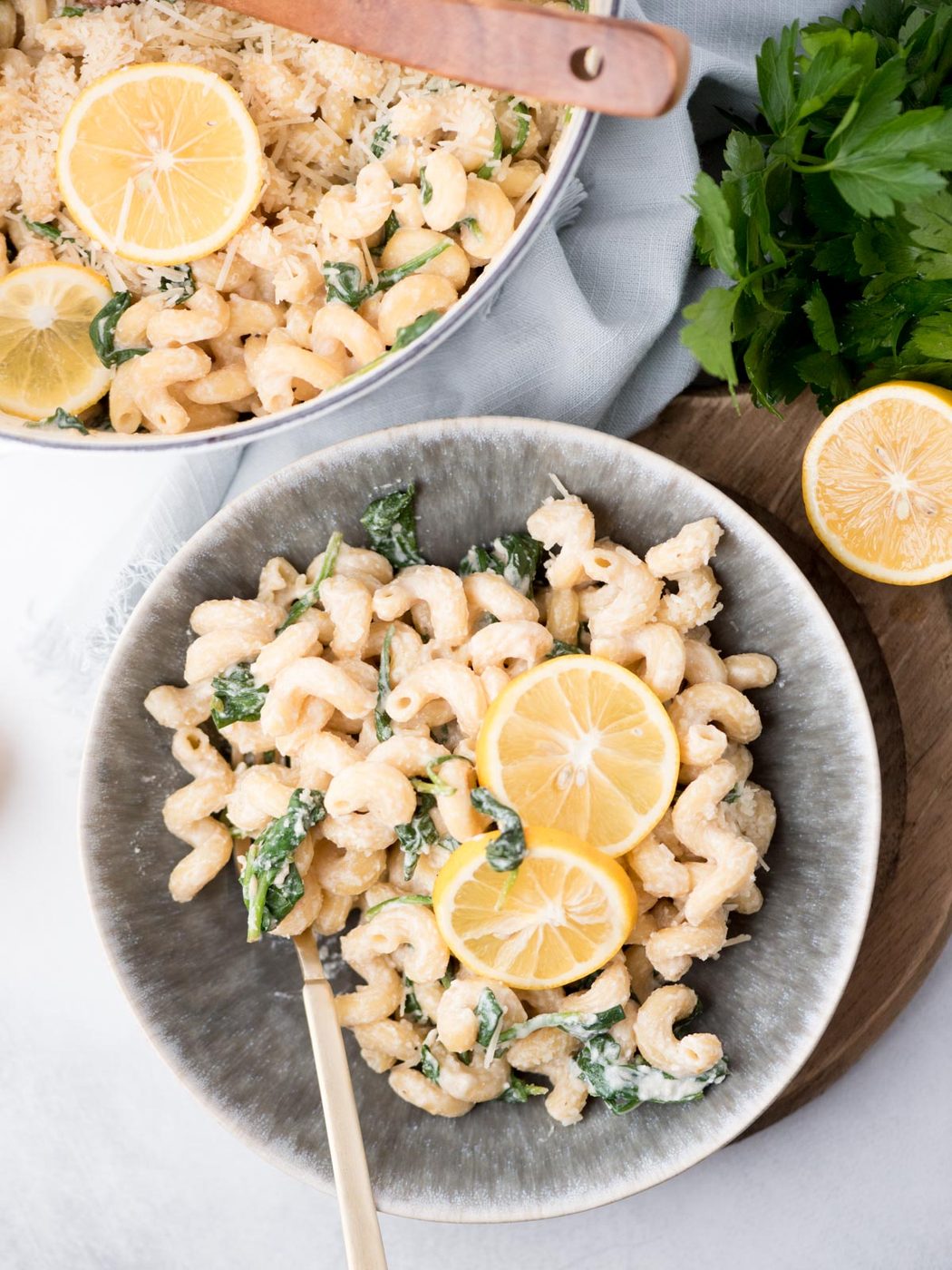 Top view of a bowl with lemon ricotta pasta and 2 lemon round garnishes in the middle.