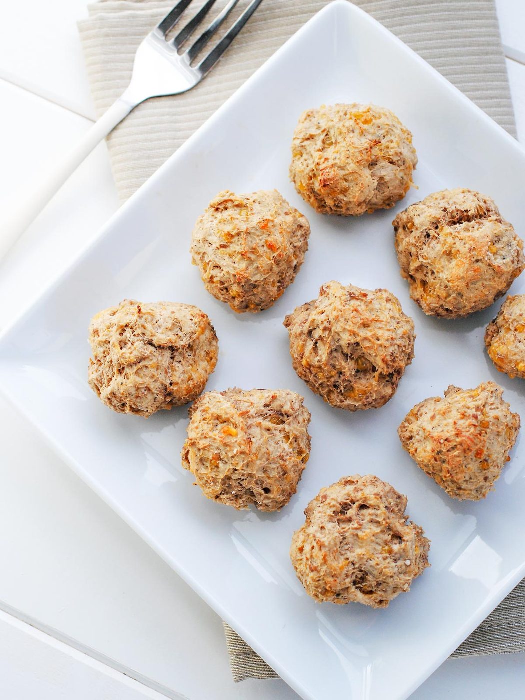 Lighter sausage balls on a white plate.
