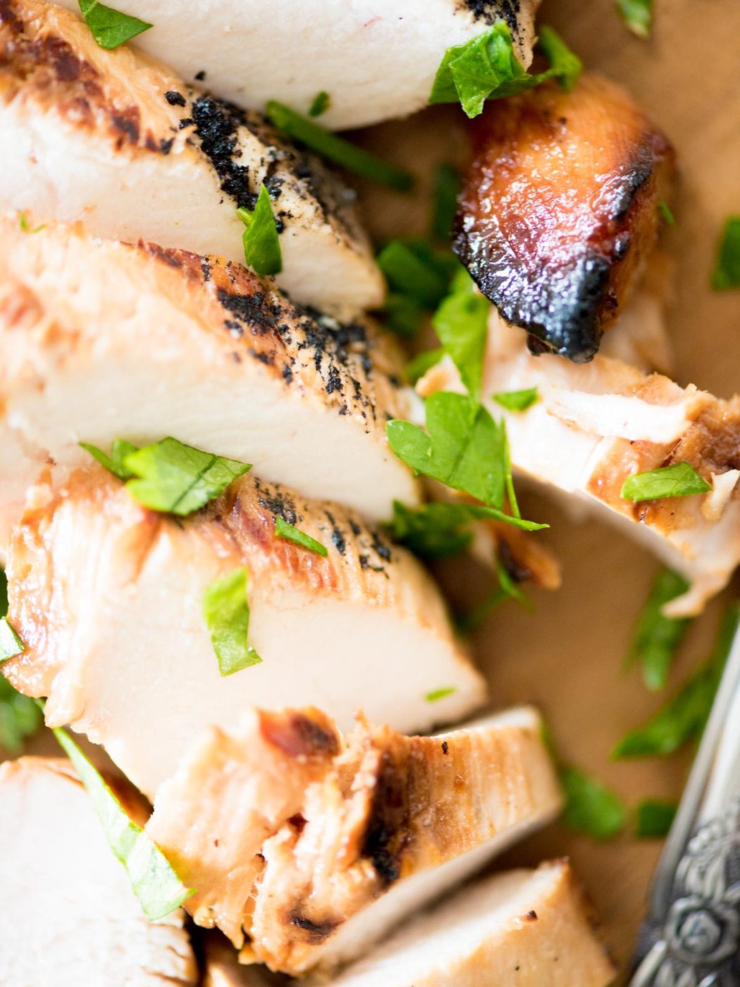 grilled marinated chicken sliced on a cutting board
