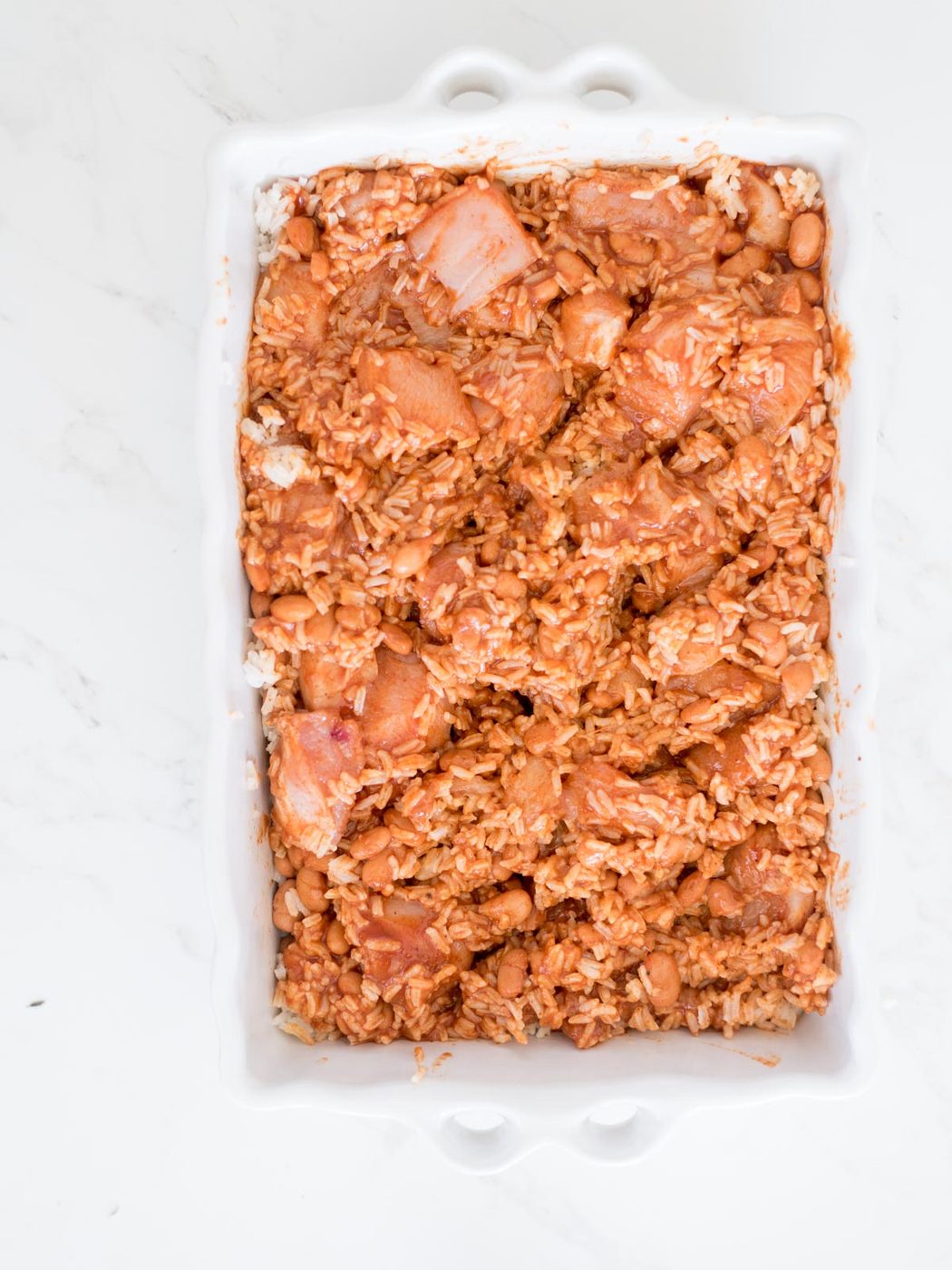 enchilada sauce mixed into the chicken rice and beans mixture