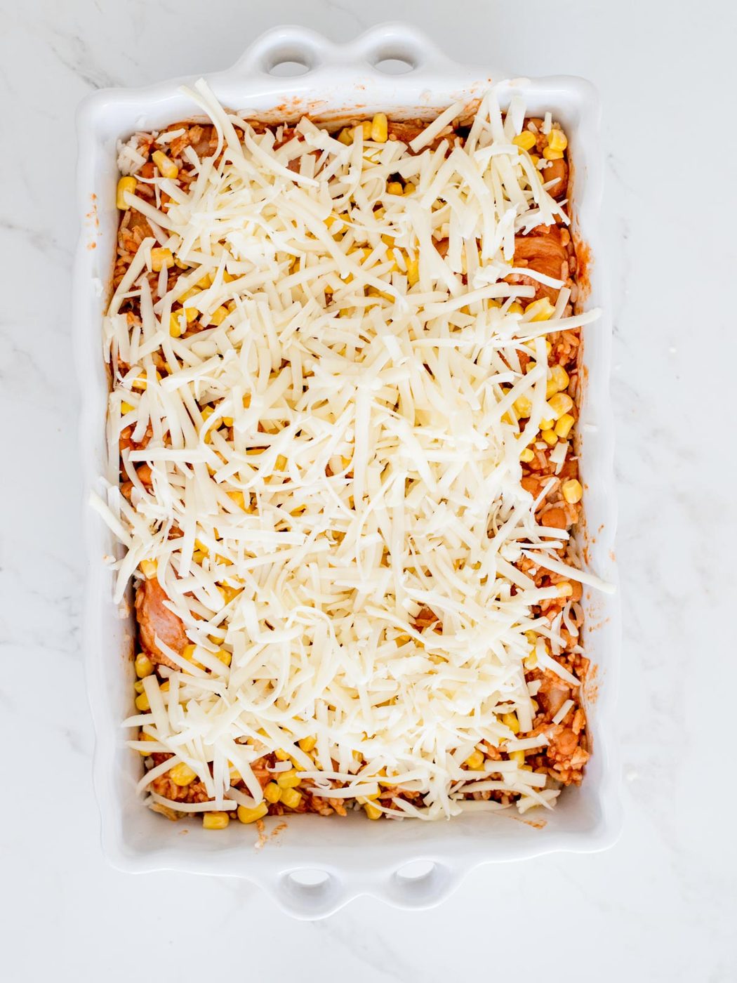 shredded cheese sprinkled over chicken mixture