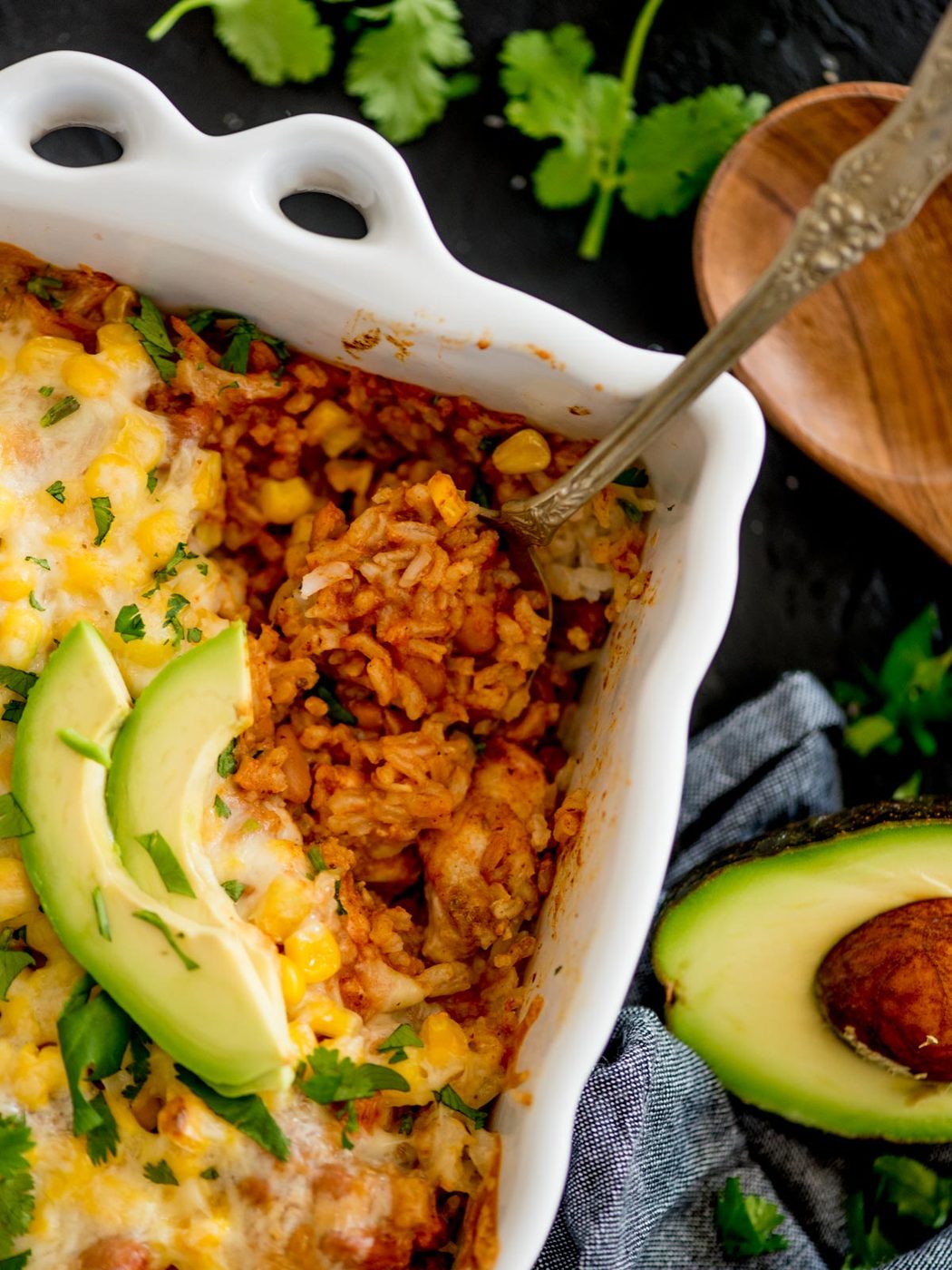 mexican rice casserole topped with cilantro and avocado