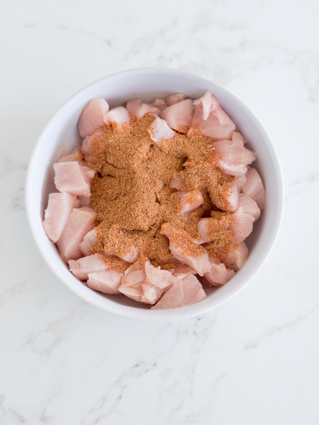 chicken and taco seasoning in a bowl