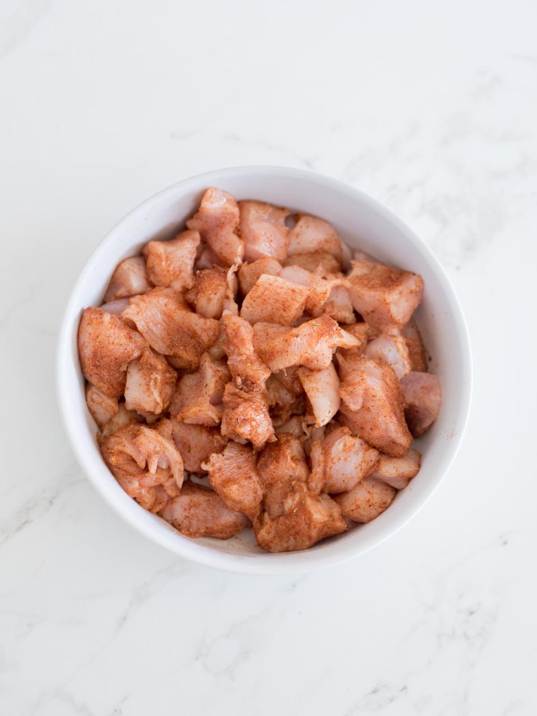 chicken mixed with taco seasoning in a bowl