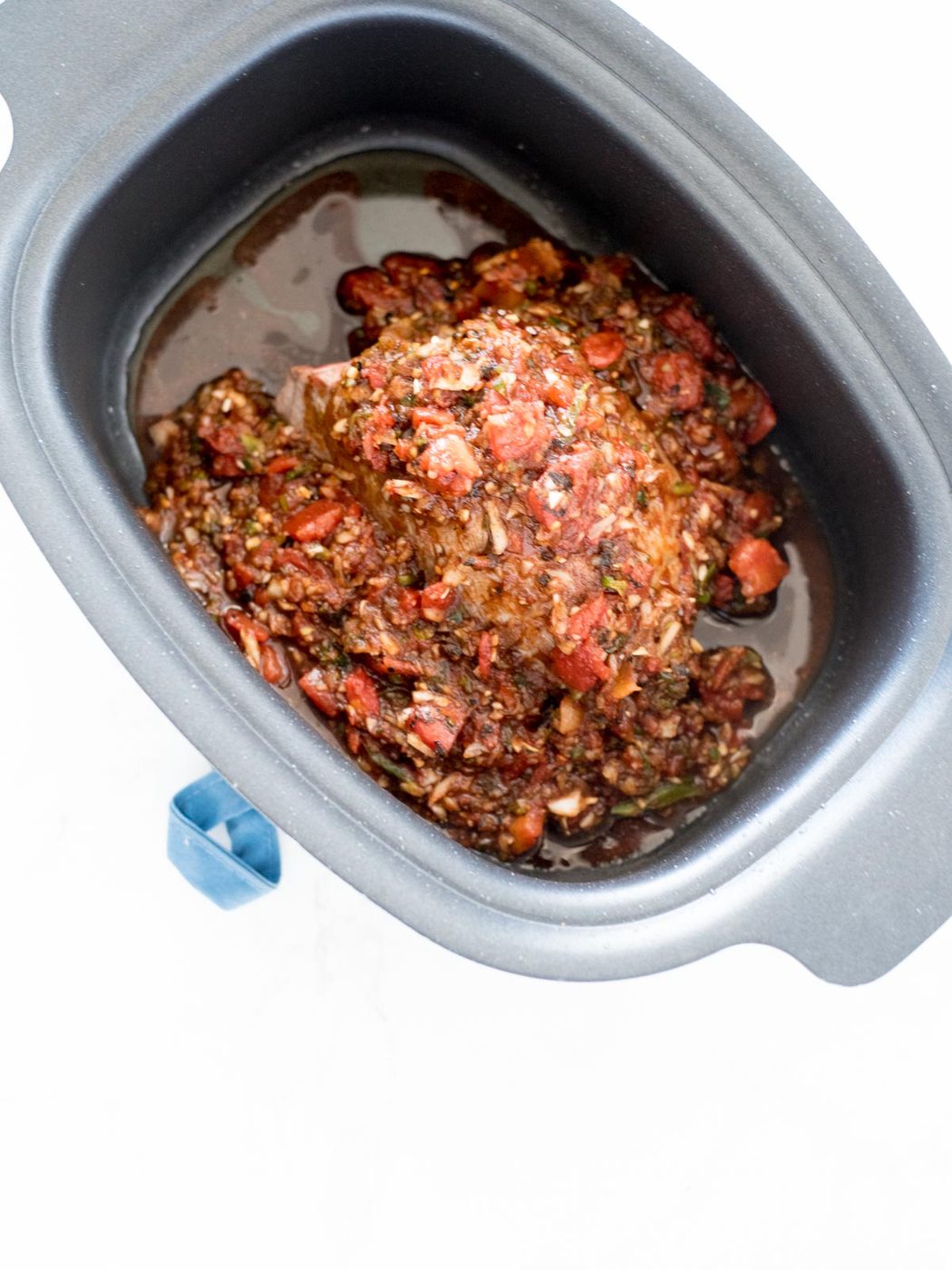 beef in crockpot with sauce poured over