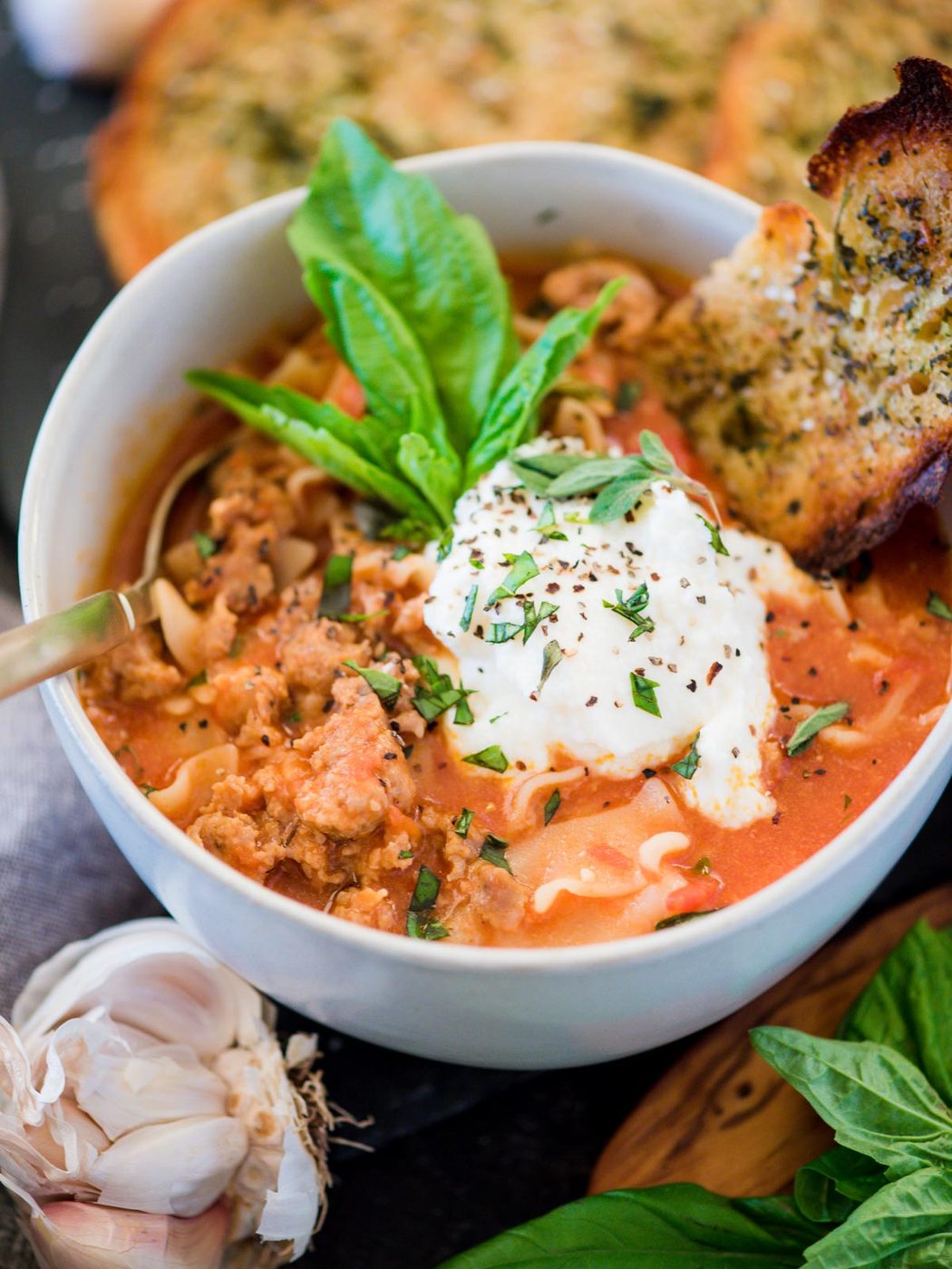 bowl of one-pot lasagna soup topped with basil and ricotta