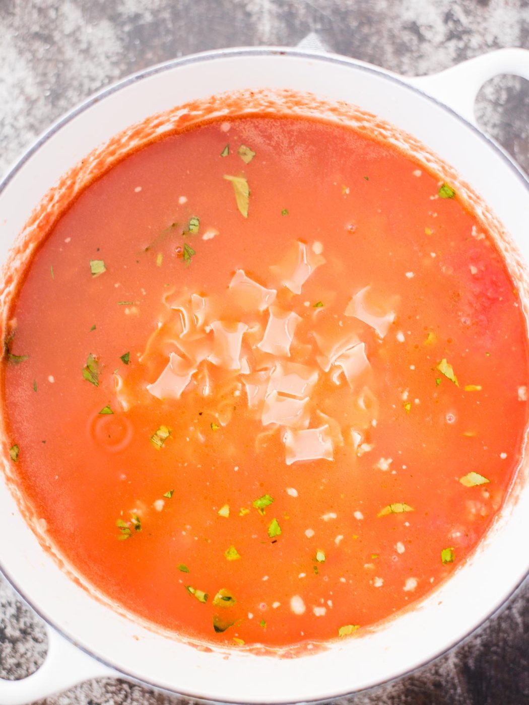 pasta being added to lasagna soup