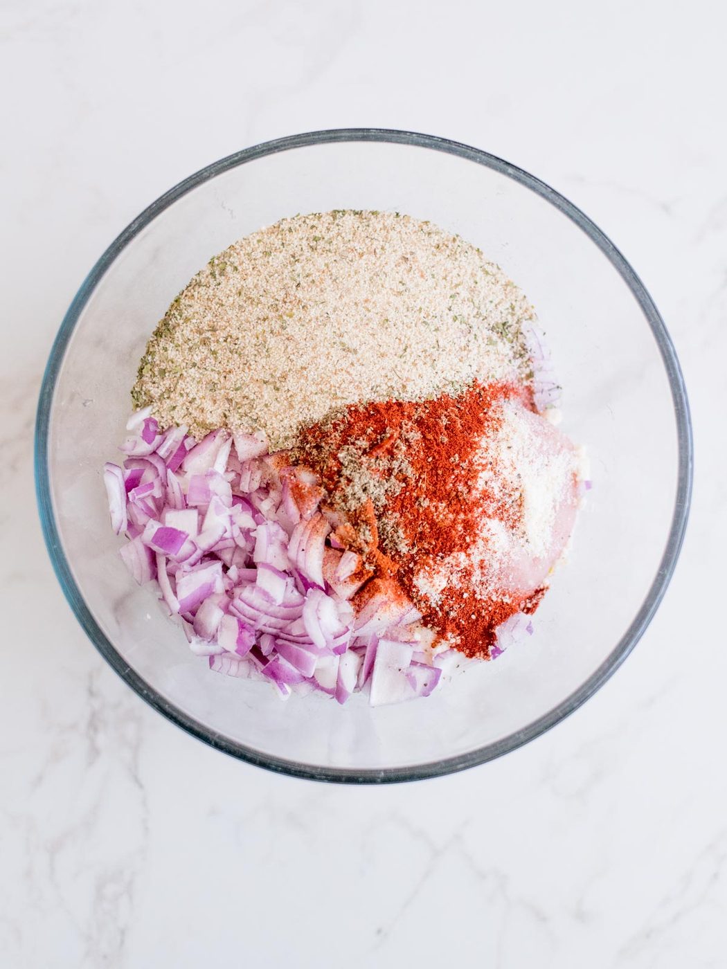ground turkey, onion, seasonings, spices, and breadcrumbs together in a mixing bowl to make turkey meatballs