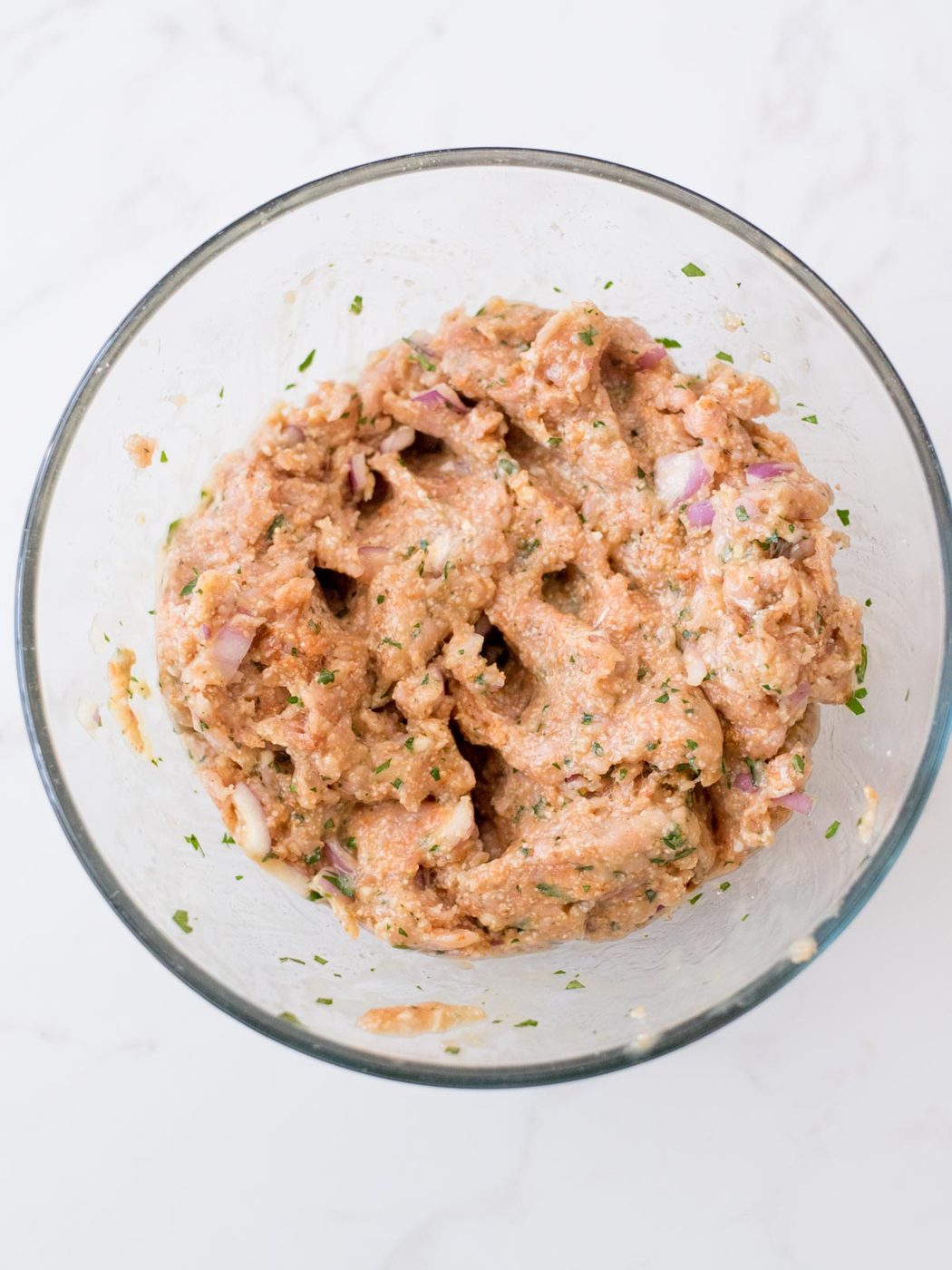 raw turkey meatball mixture in a mixing bowl