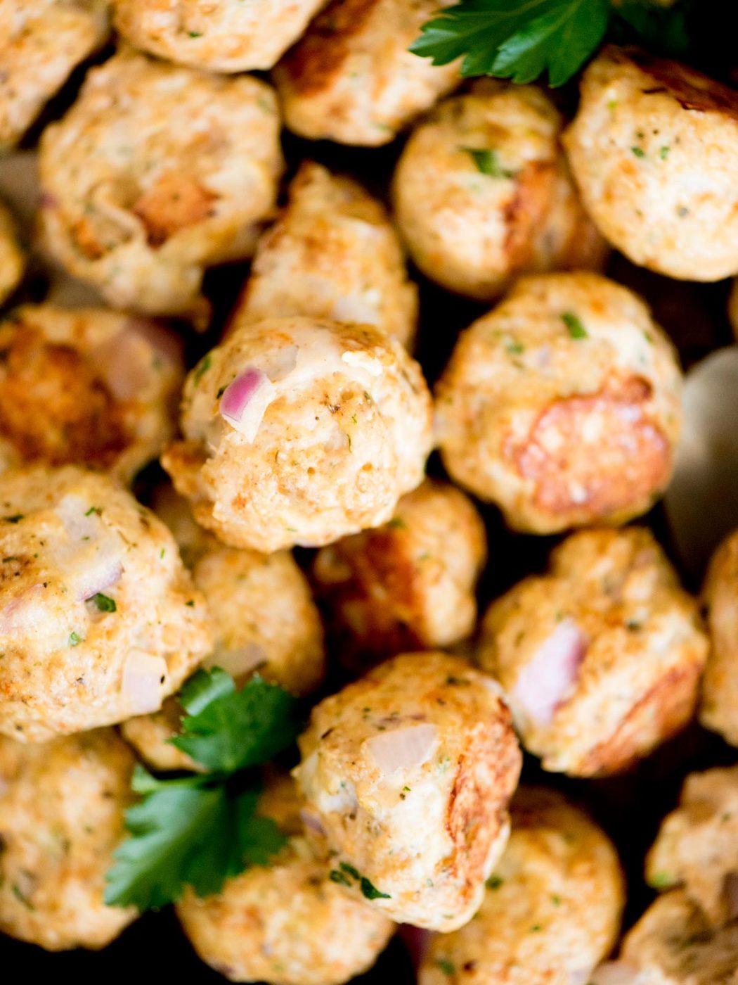 from-scratch turkey meatballs stacked on a baking sheet