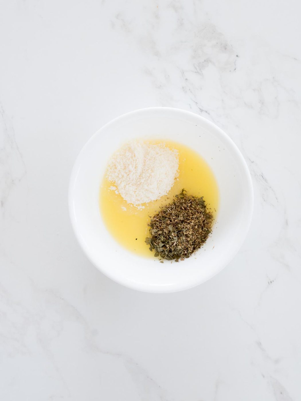 herbs added to butter and parmesan