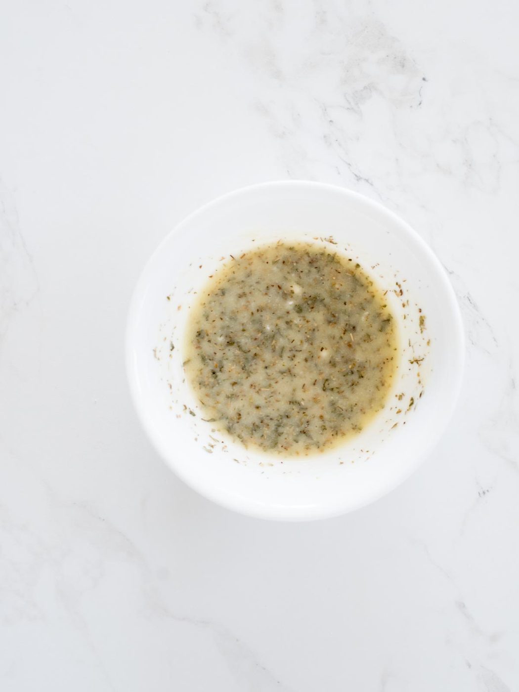 melted butter, parmesan, and herbs mixed together in a bowl