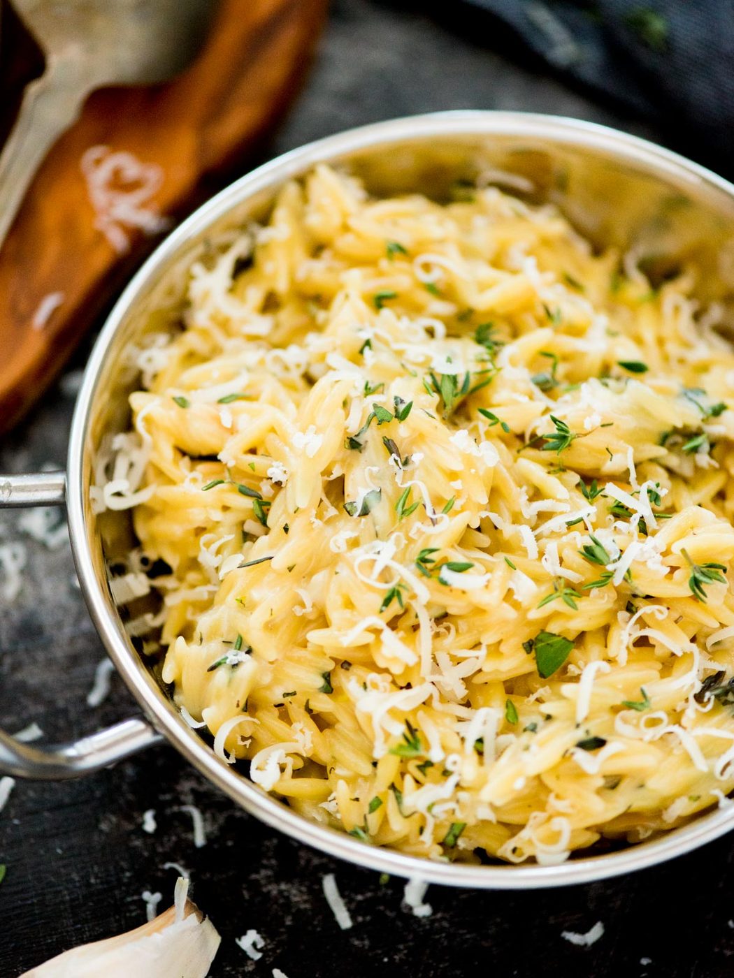 parmesan orzo topped with fresh herbs and grated parmesan