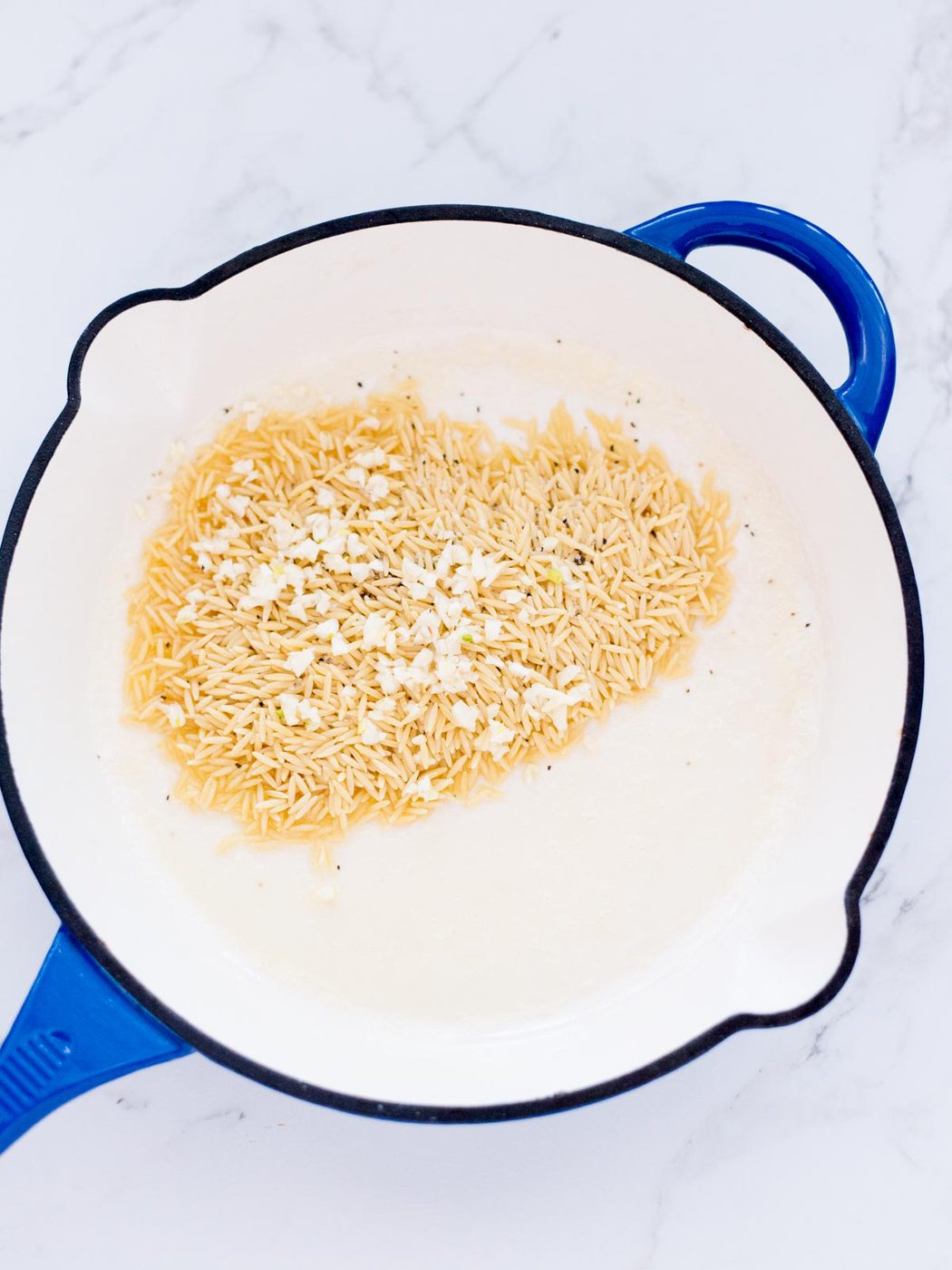 garlic added to the orzo, salt, pepper, and butter