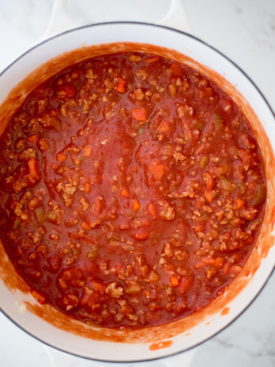 canned tomatoes stirred into the sausage mix in dutch oven