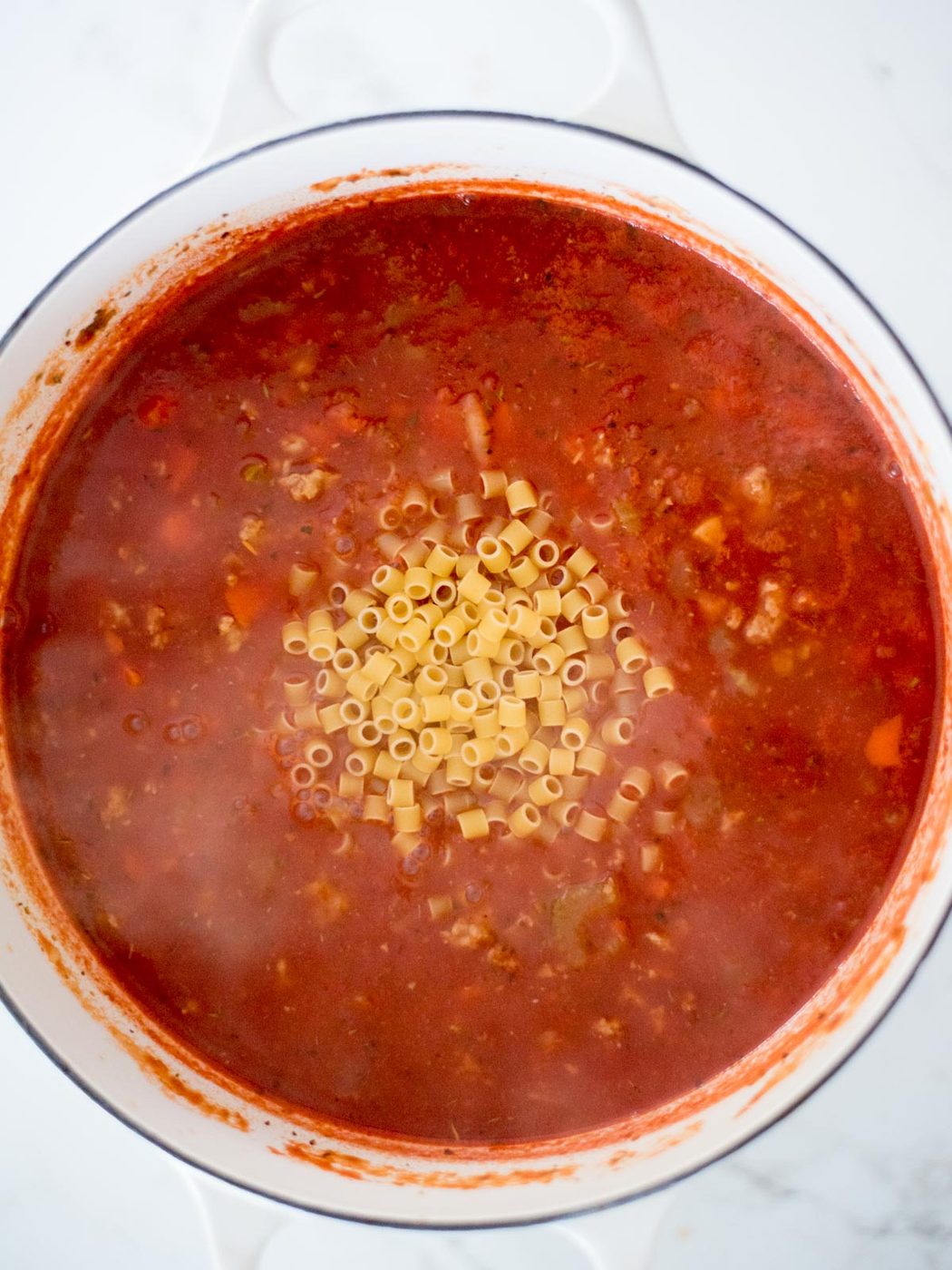 ditalini pasta added to the dutch oven pot