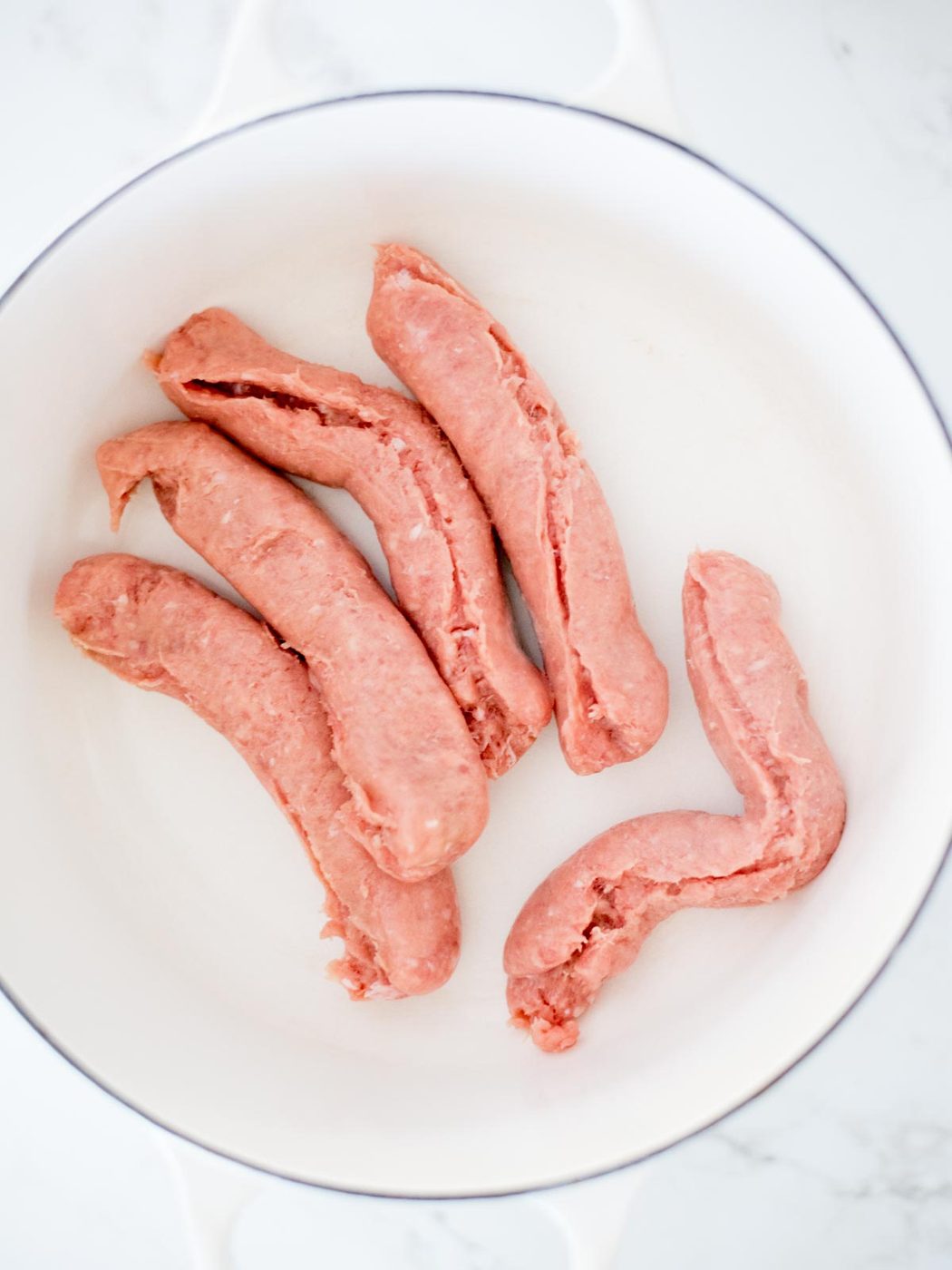 turkey italian sausage in an enamel cast iron dutch oven