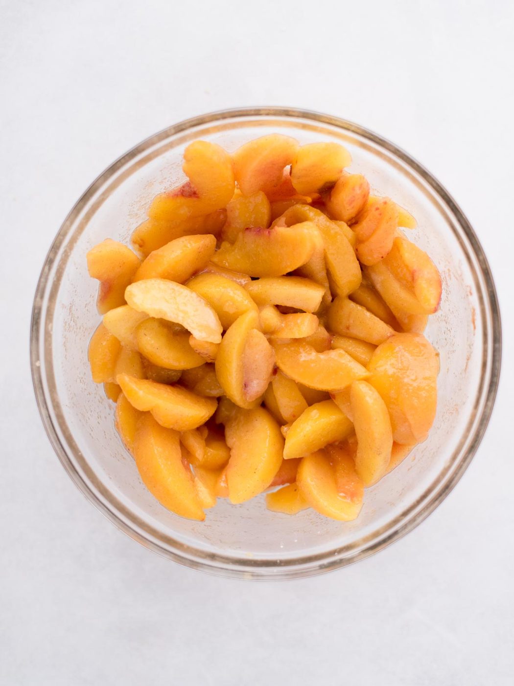 Peaches in a glass bowl.