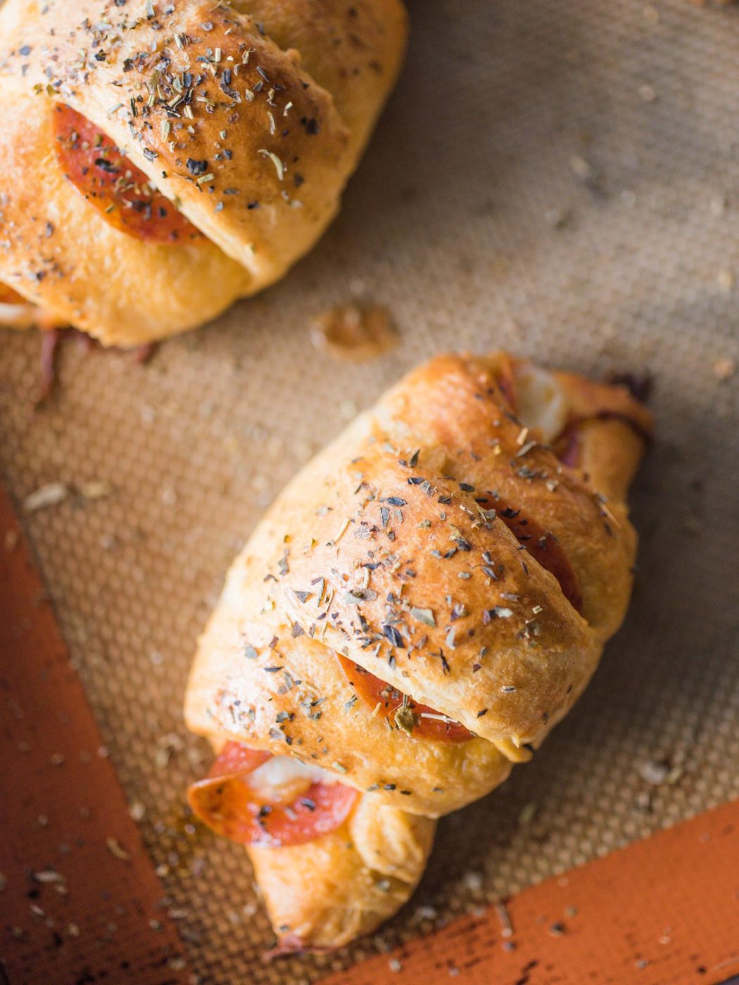 pepperoni rolls on silpat lined baking sheet