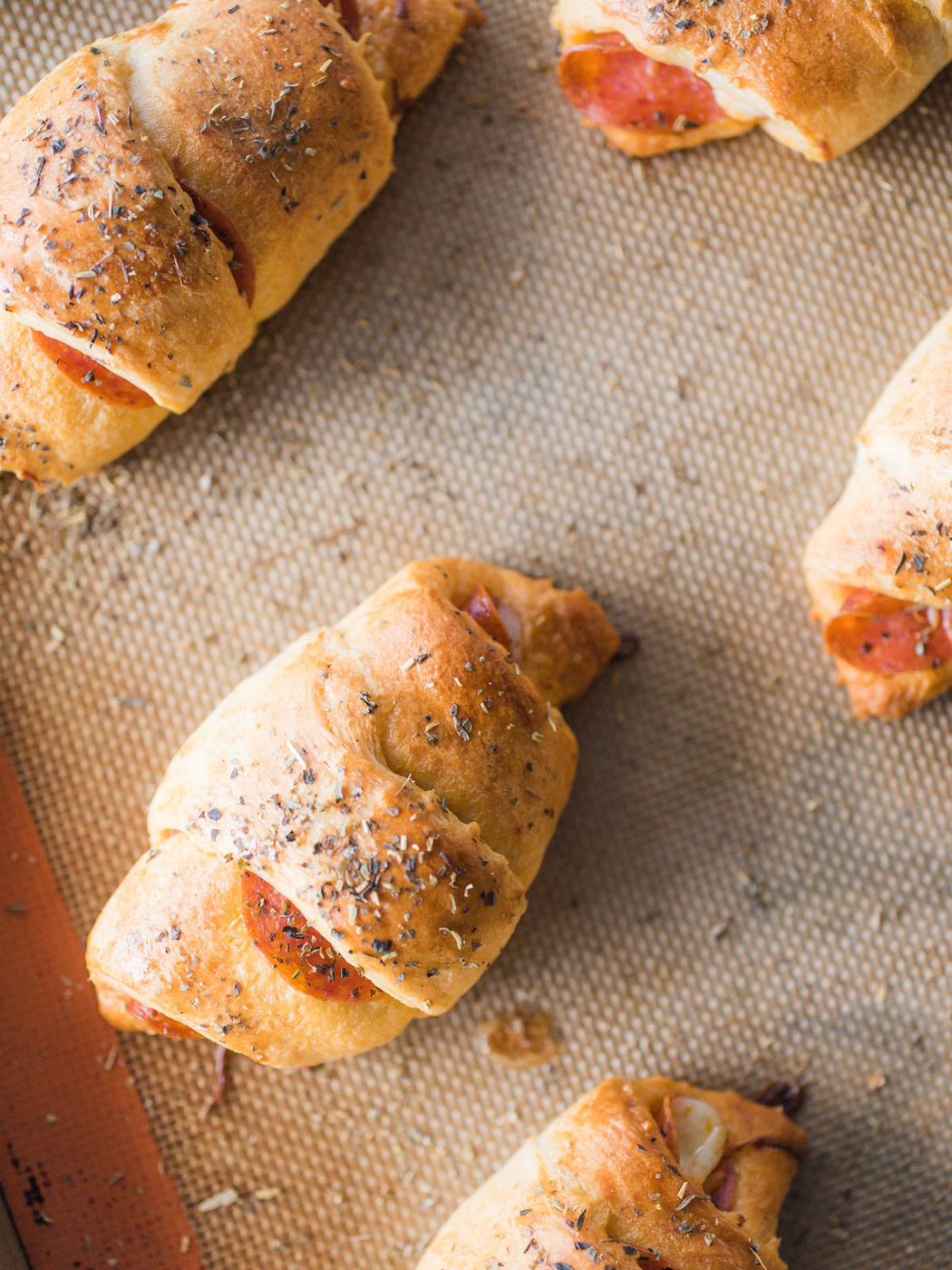 pepperoni rolls on silpat lined baking sheet