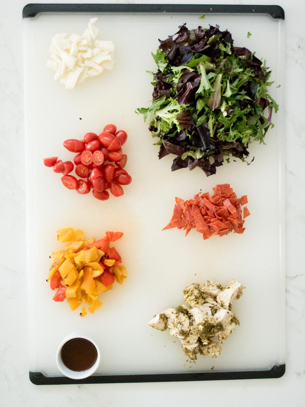 ingredients on a cutting board for pesto chicken mason jar salad
