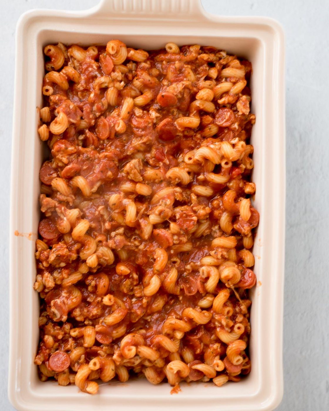 unbaked pizza casserole in a baking dish