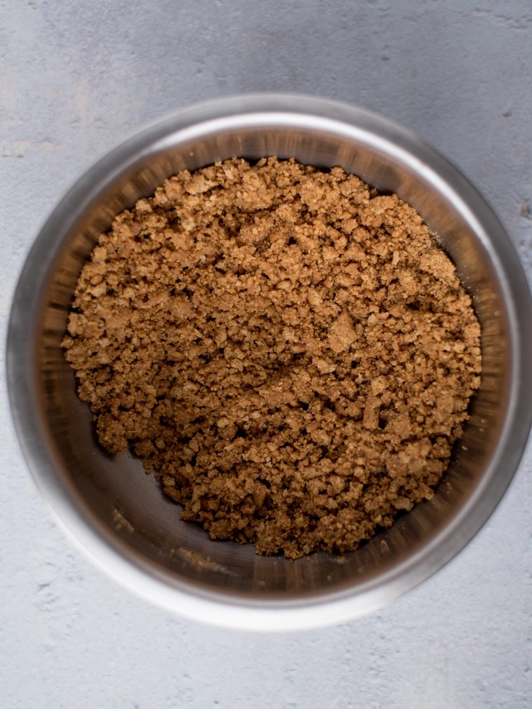 graham cracker crust ingredients mixed together in a bowl