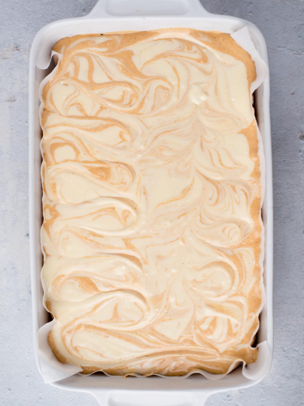 unbaked cheesecake bars swirled in a 9x13 dish