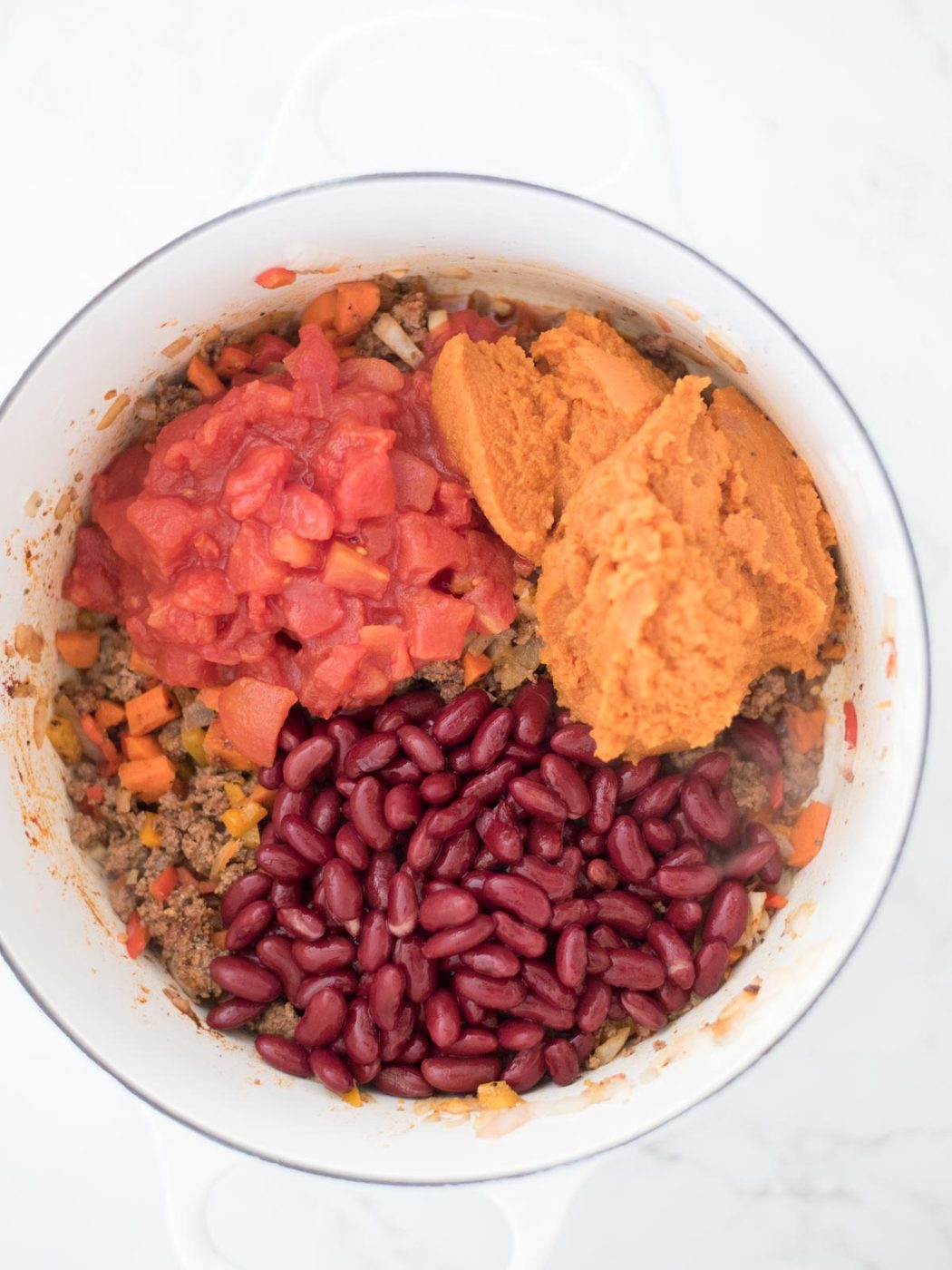tomatoes, pumpkin, and beans added to the beef and vegetable mixture