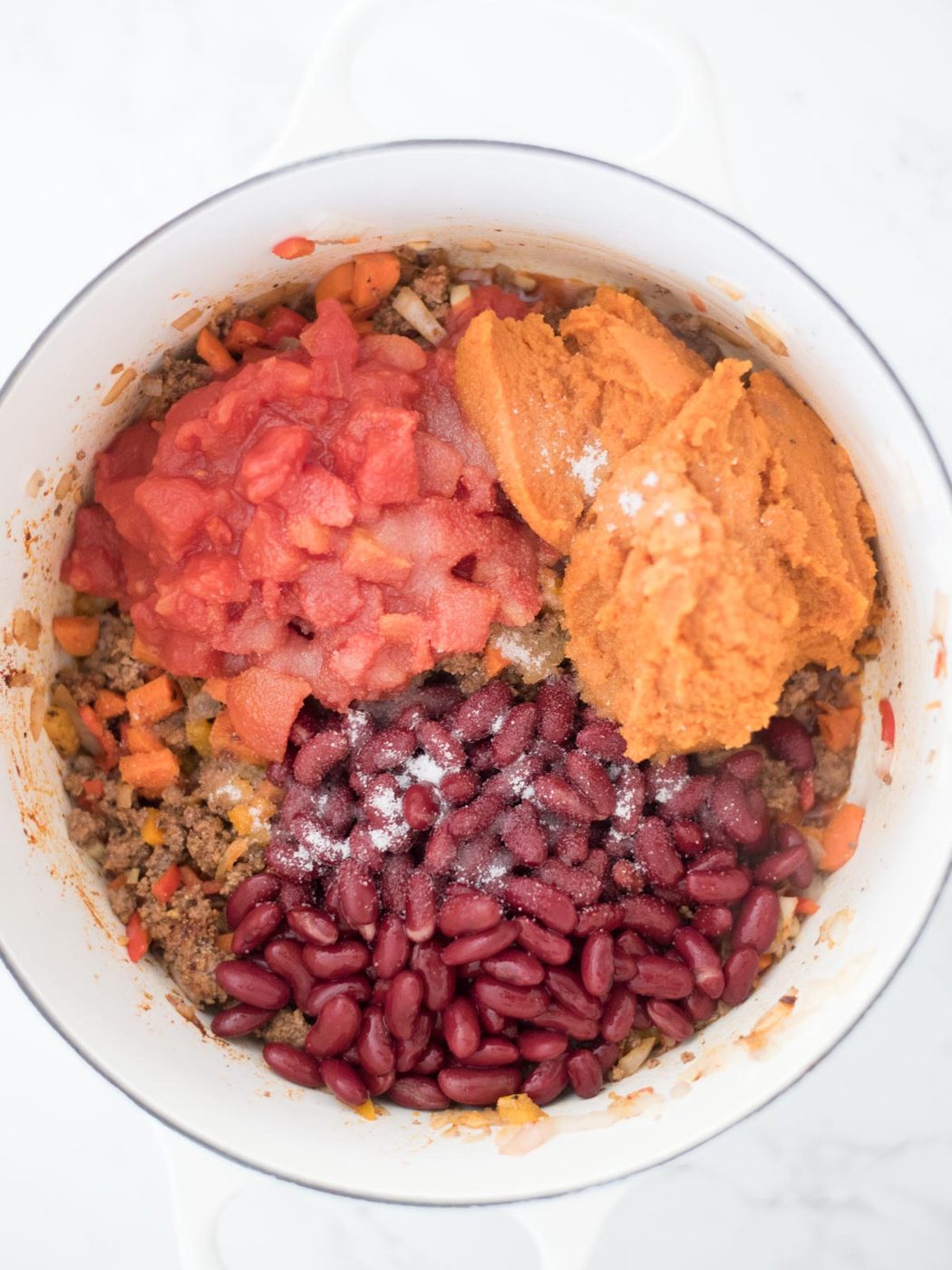 sugar added to the beans, tomatoes, and pumpkin in the dutch oven