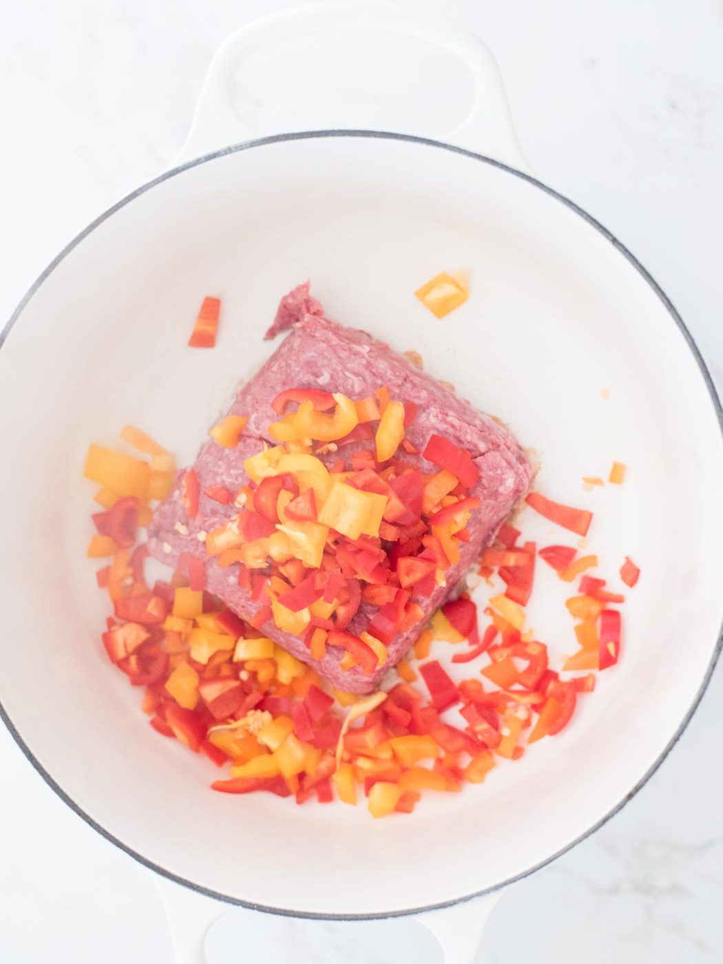 bell pepper added to the ground beef of a dutch oven