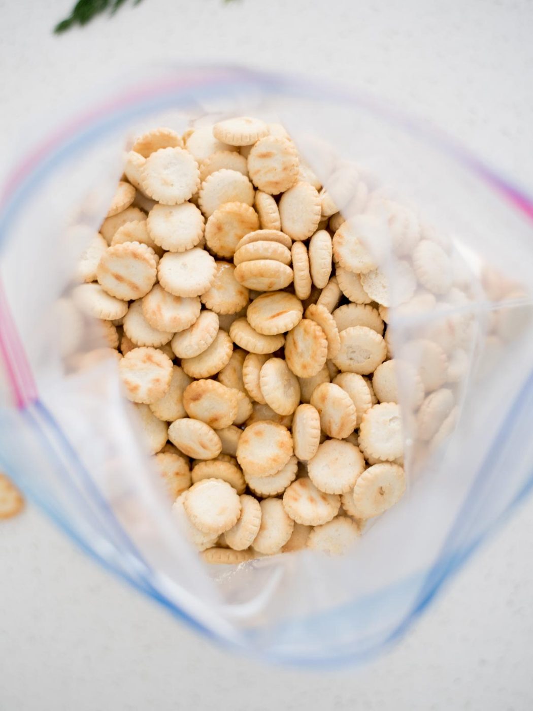 Open ziploc bag with oyster crackers inside.