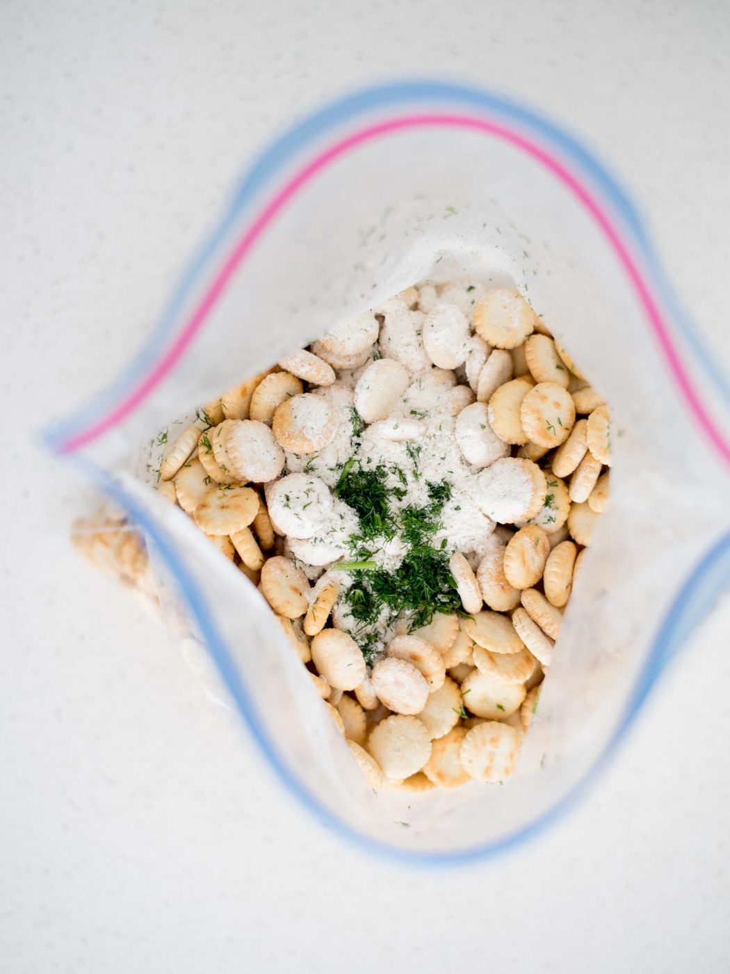 Ziploc bag of oyster crackers and seasonings added to the bag.