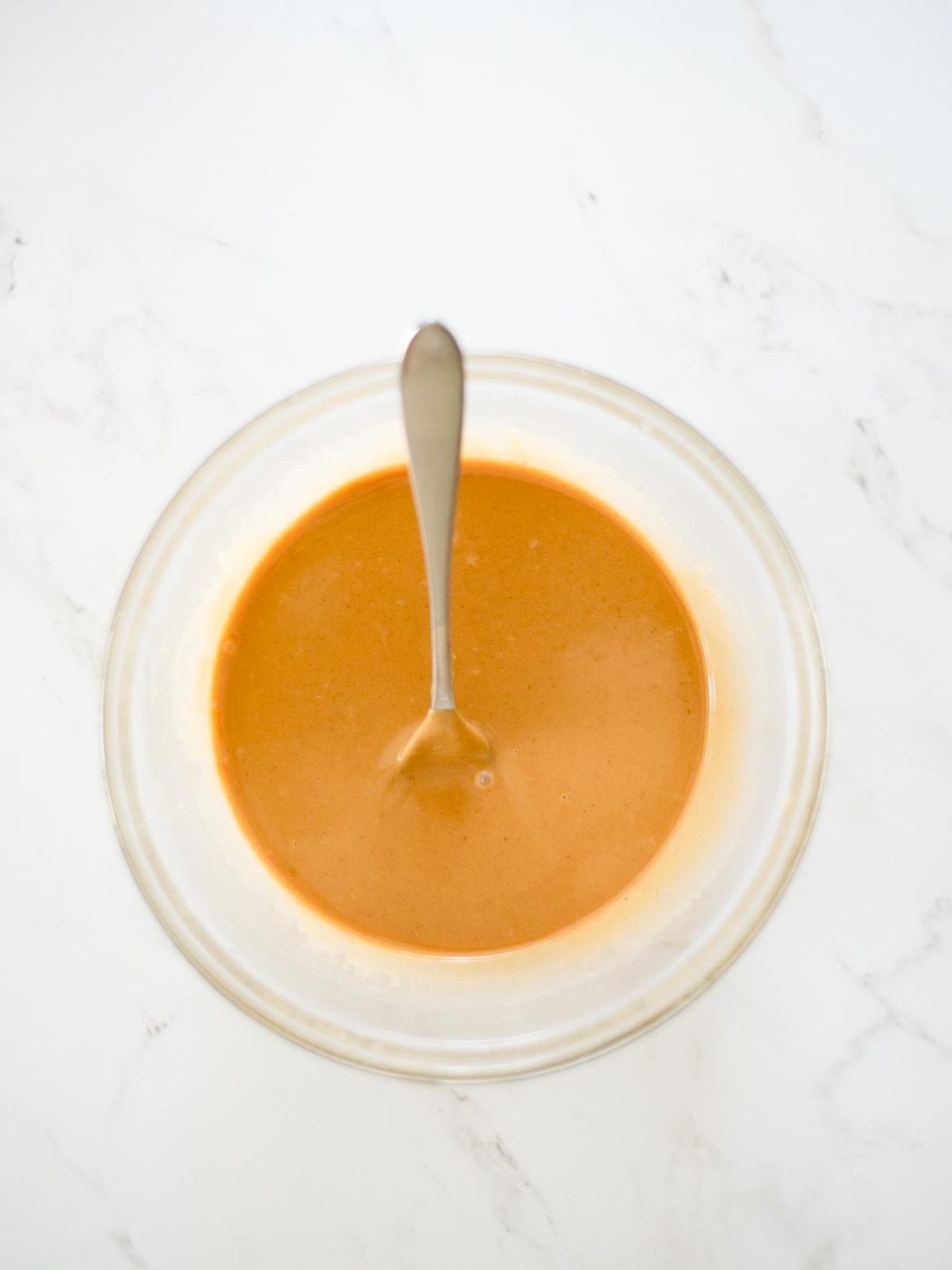 melted butter and peanut butter mixed together in a bowl